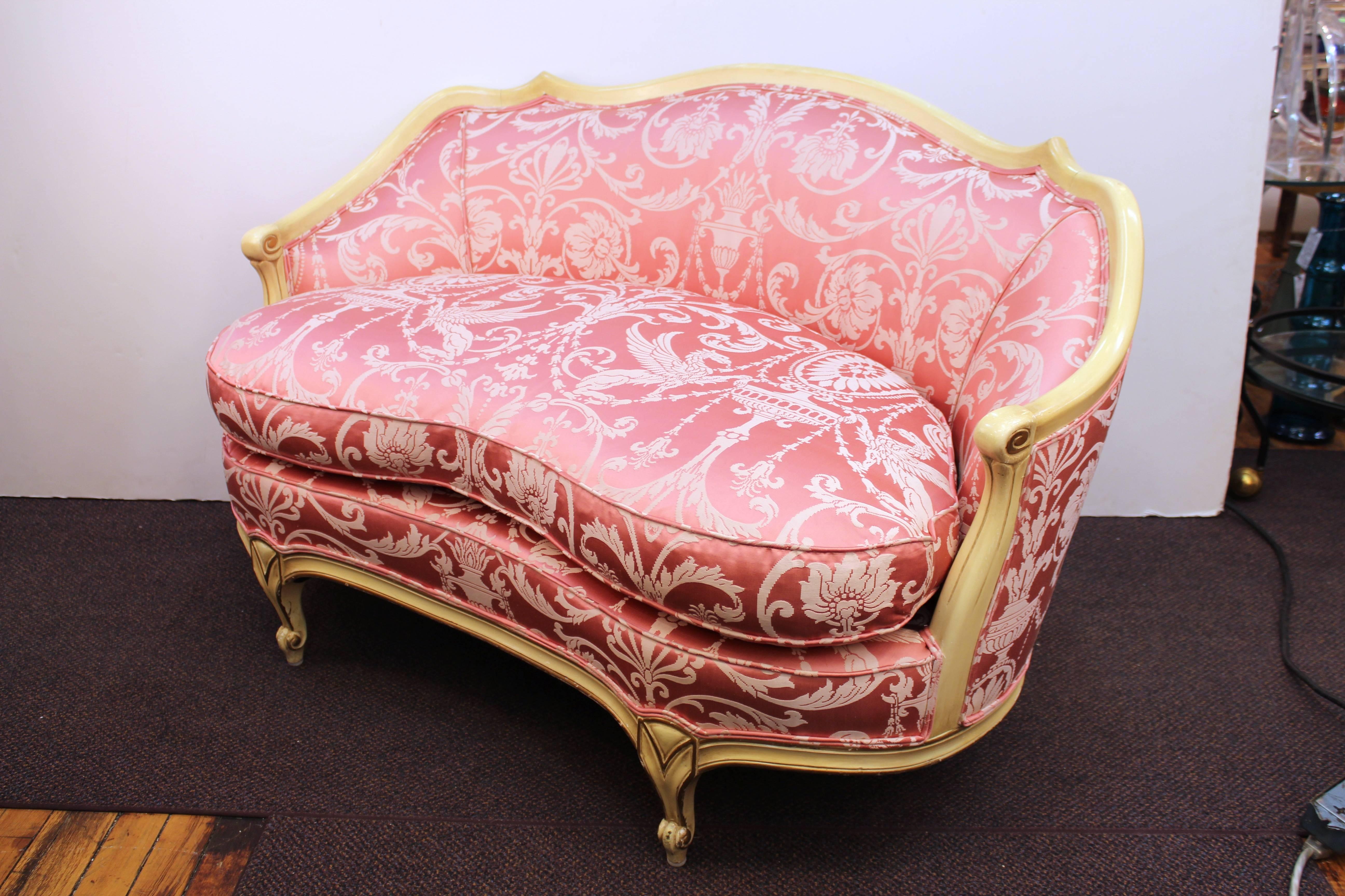 A pair of settees or loveseats in Neoclassical French style, reupholstered in a decorative classical pink jacquard fabric. The pair is in great vintage condition.