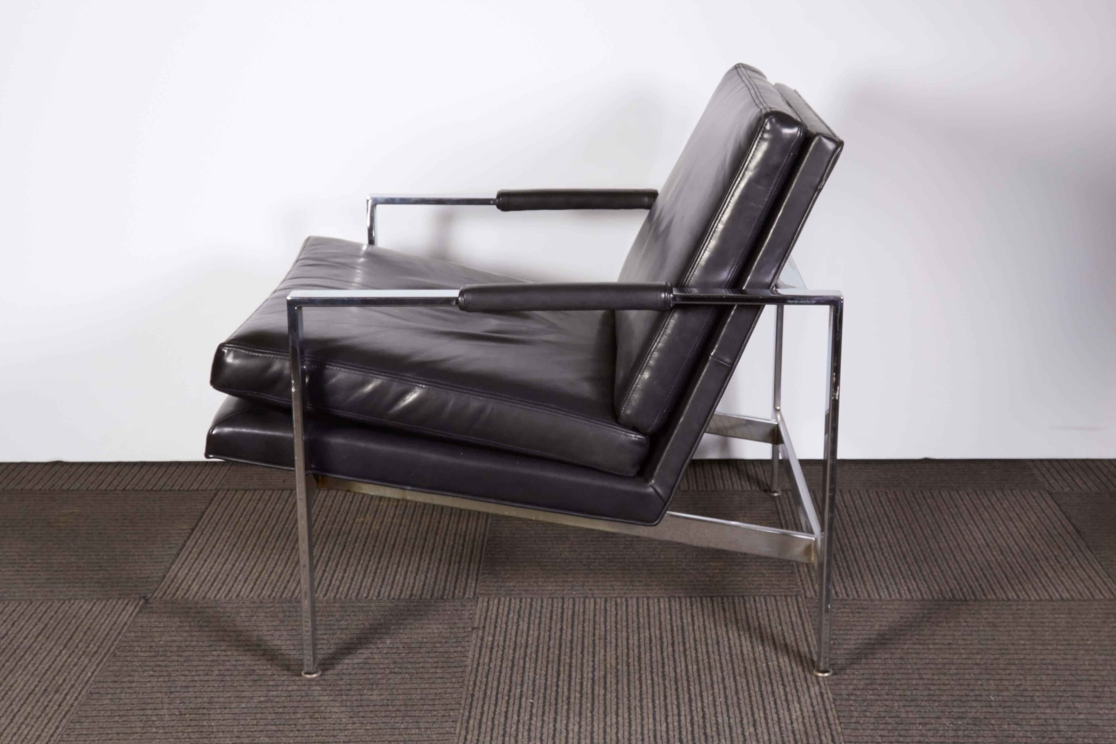 A club armchair by designer Milo Baughman, back, seat and armrests upholstered in black leather, against modern linear chrome frame, circa 1970s. Excellent vintage condition, newly reupholstered.

 