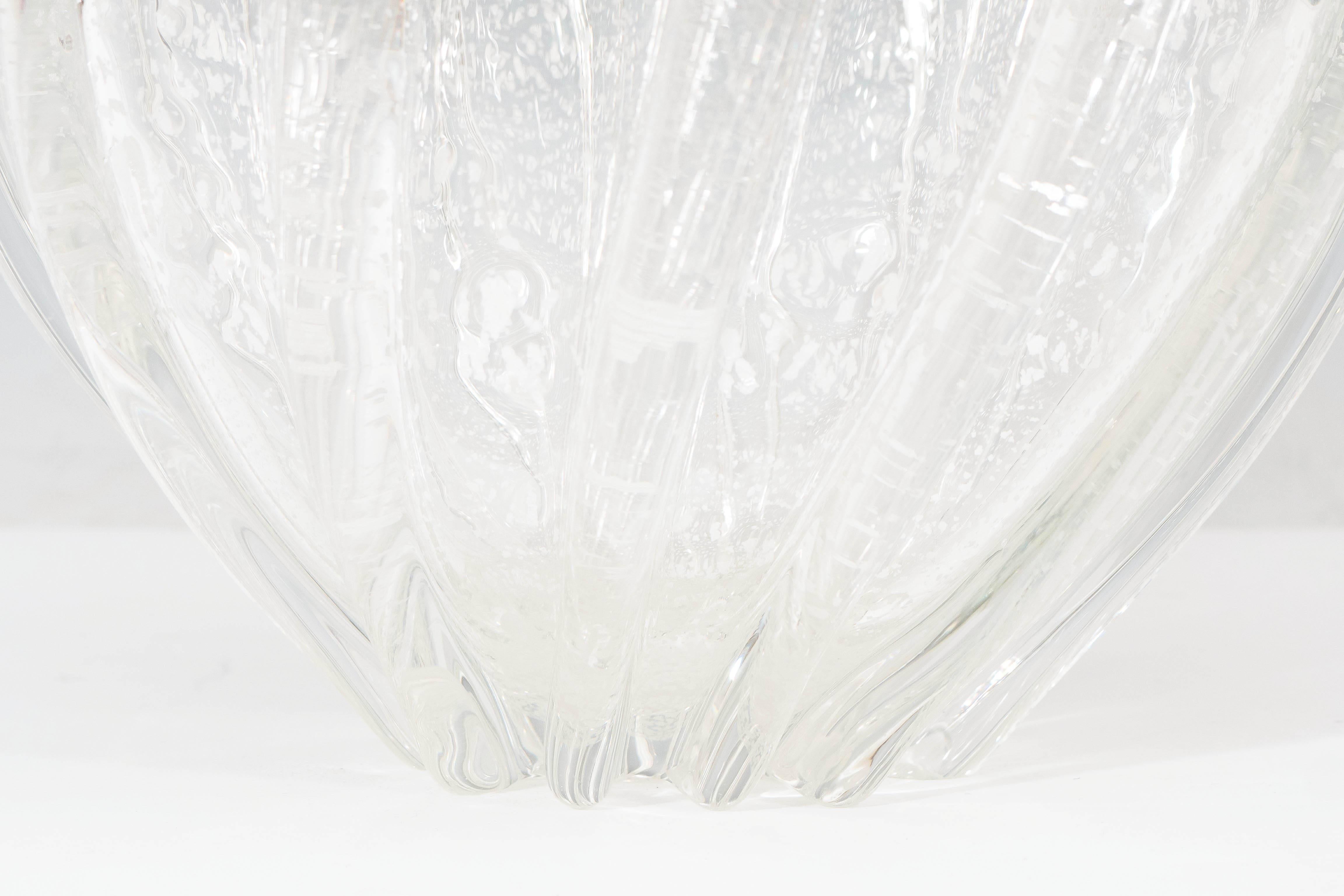 A Murano glass 'Pillow' vase after Seguso, produced, circa 1960s with ribbed body, infused with silver leaf flecks. This glass remains in very good vintage condition, consistent with age.