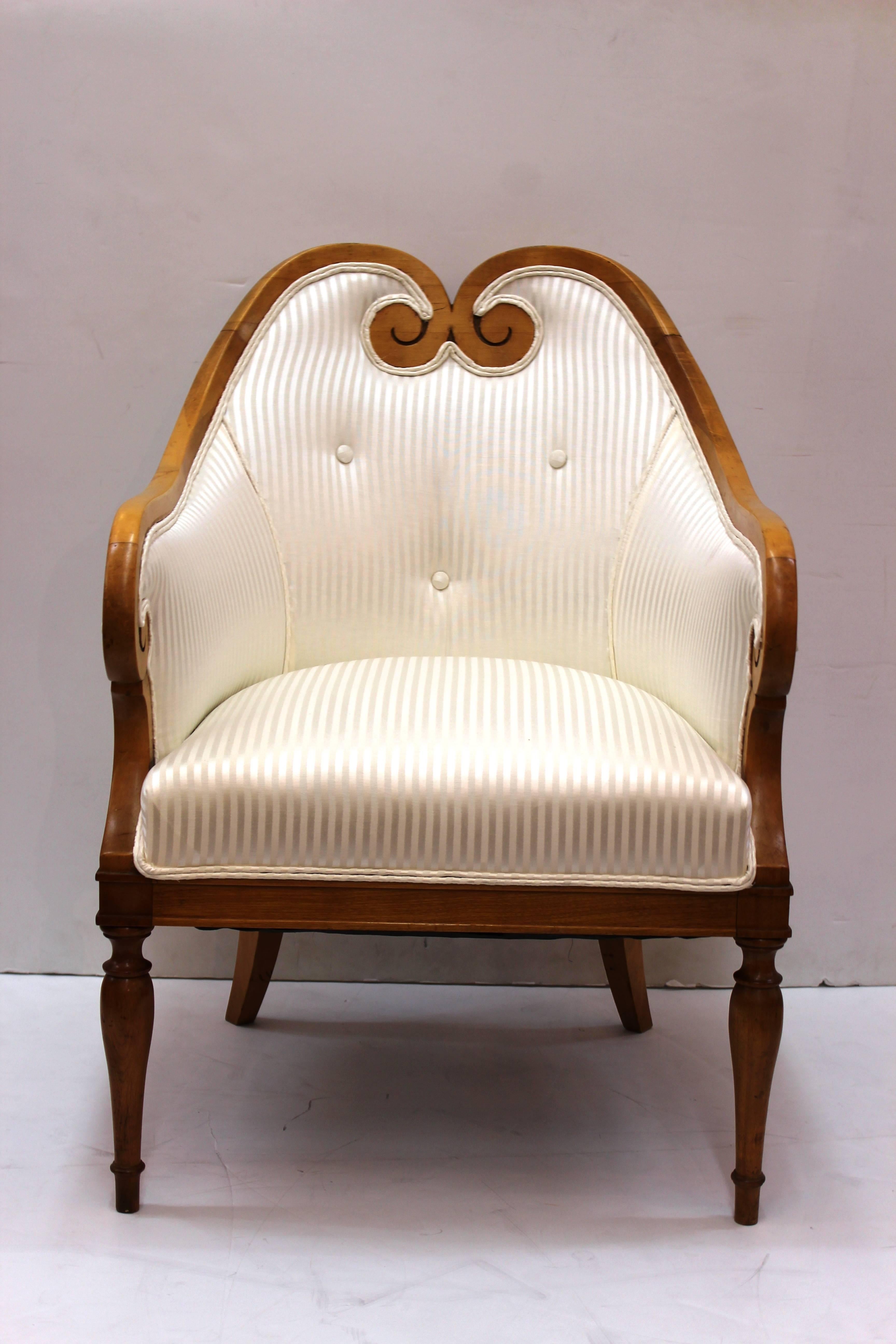 Biedermeier occasional chairs dating from the 19th century. Details include blond wood frame with sweet heart back and curled arms. The chairs stand on one pair of baluster legs with curved back legs. Newly reupholstered in white tone on tone