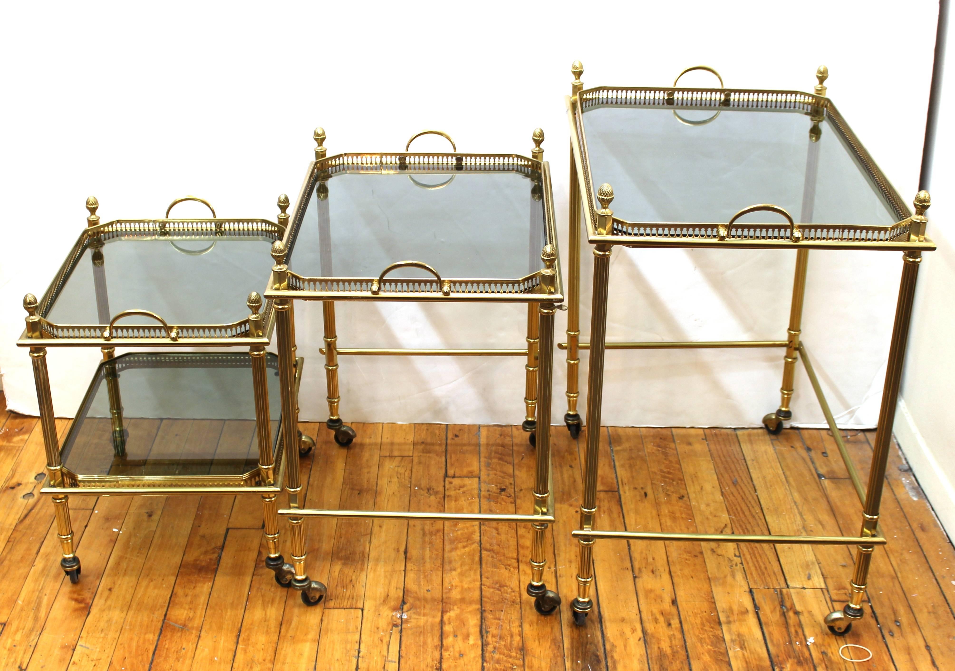 Maison Baguès Nesting Tables in Brass and Smoked Glass on Casters In Excellent Condition In New York, NY