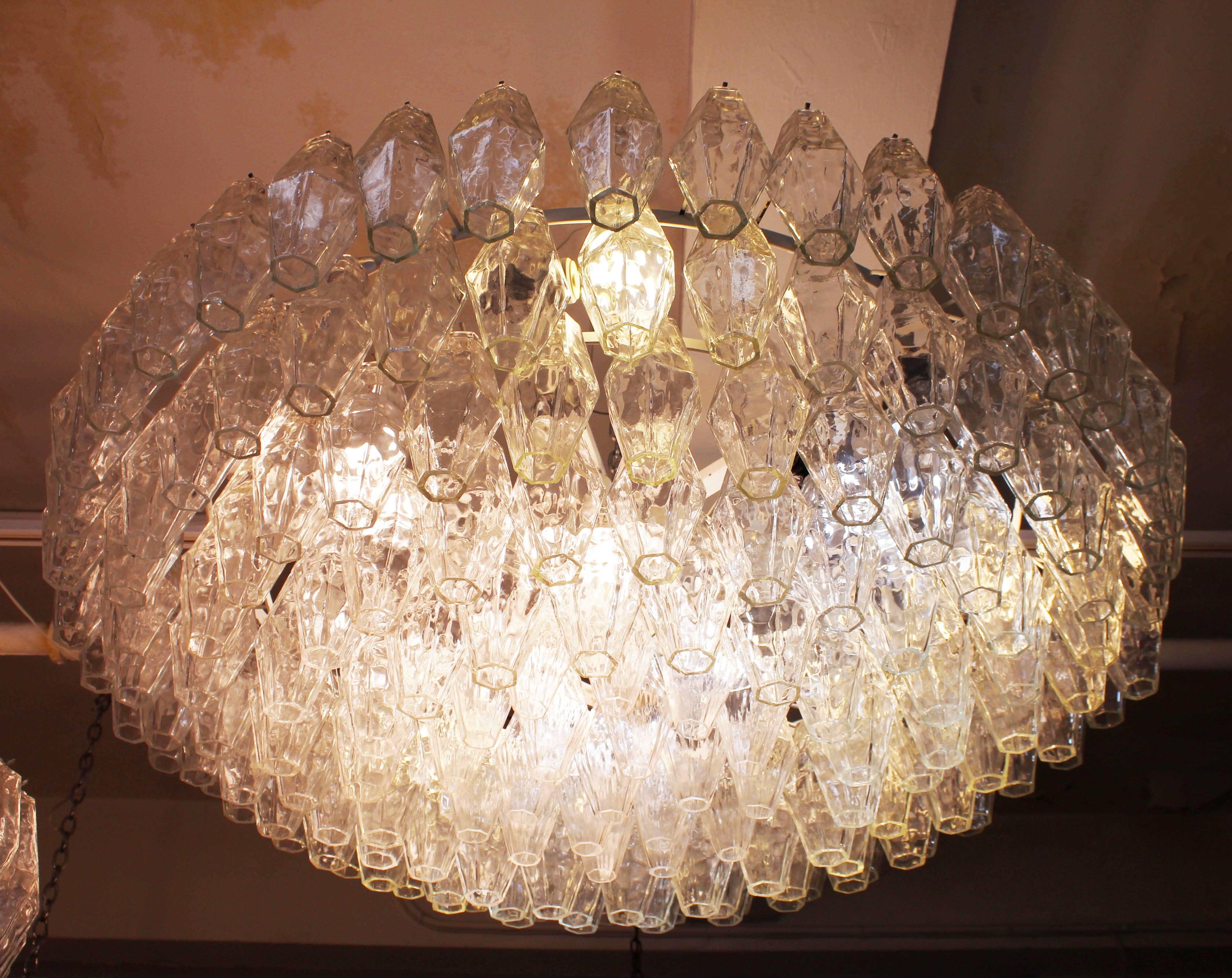 Large sized Murano glass chandelier, made of multiple tiers of polyhedral glass prisms on a white metal frame. The chandelier was made in Italy in the 1960s. The piece remains in good vintage condition, with some loss of paint finish to frame and