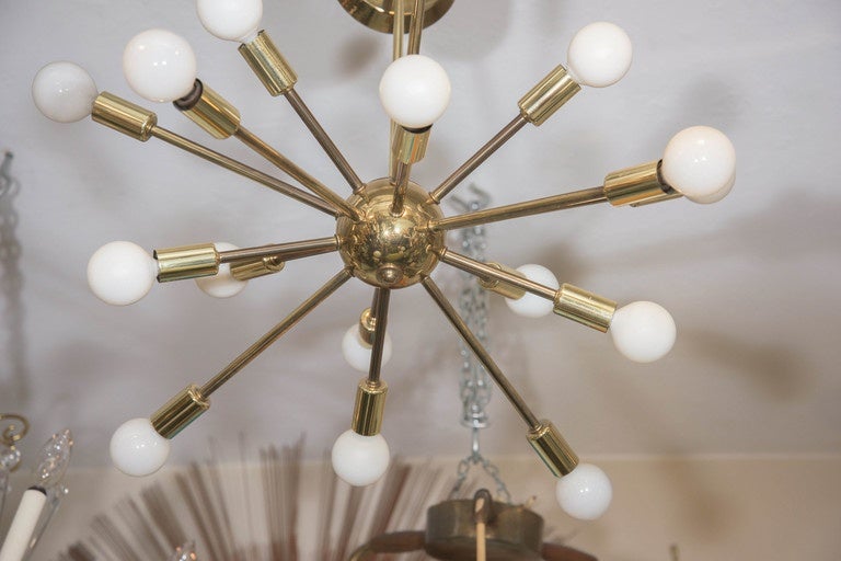 A vintage Sputnik chandelier, with fifteen arms and socket covers, extending from the central nucleus, suspended from a circular canopy and rod, in plated brass. Requires 15 Edison base bulbs, preferably round, as seen in additional images. Good