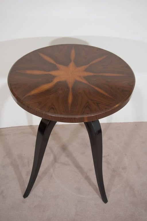 A vintage Art Deco side table, produced circa 1940s, with bookmatched burl wood veneer top on curved ebonized tripod legs. Very good vintage condition, with age appropriate wear.