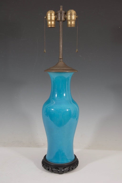 A pair of vintage, circa 1950s ceramic turquoise table lamps, each with double cluster sockets (two pull chains included), on elongated stem and cover in brass, above a baluster form body, styled after a Chinese ginger jar, on circular bases in