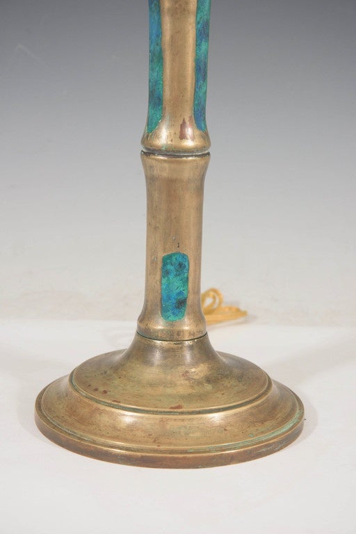 A pair of vintage candlestick table lamps, produced in Mexico by Pepe Mendoza, designed with faux bamboo stalk motif in bronze, inlaid with enameled turquoise ceramic, on circular bases. Markings include maker stamps, set against the base and top of