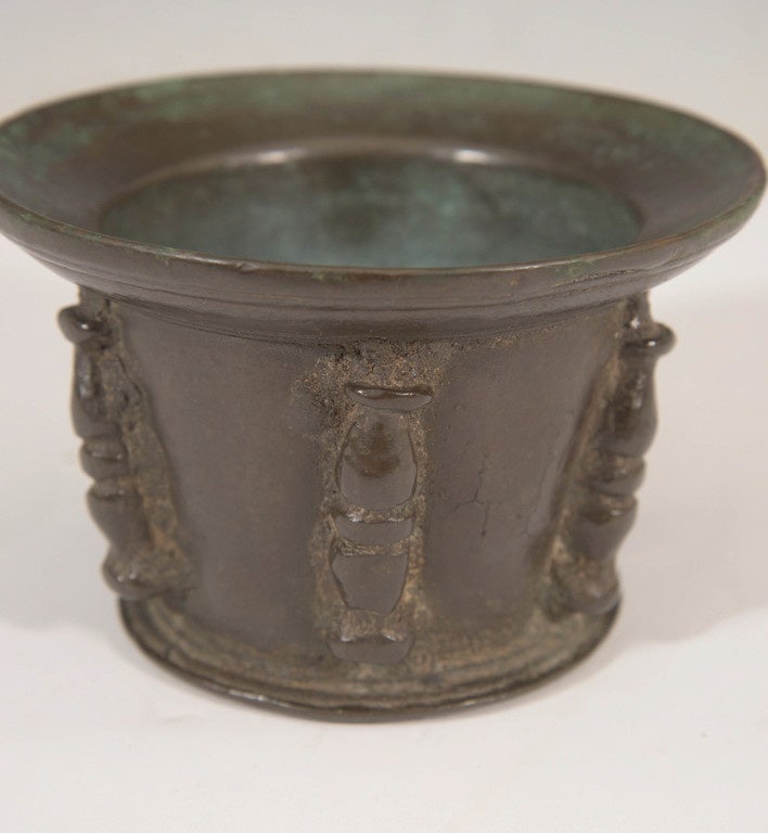 A Renaissance period bronze mortar, common throughout the 16th and 17th centuries, possibly Italian or Spanish in origin, with a flared lip, the body decorated with baluster column forms. Good antique condition, with age appropriate wear and patina.