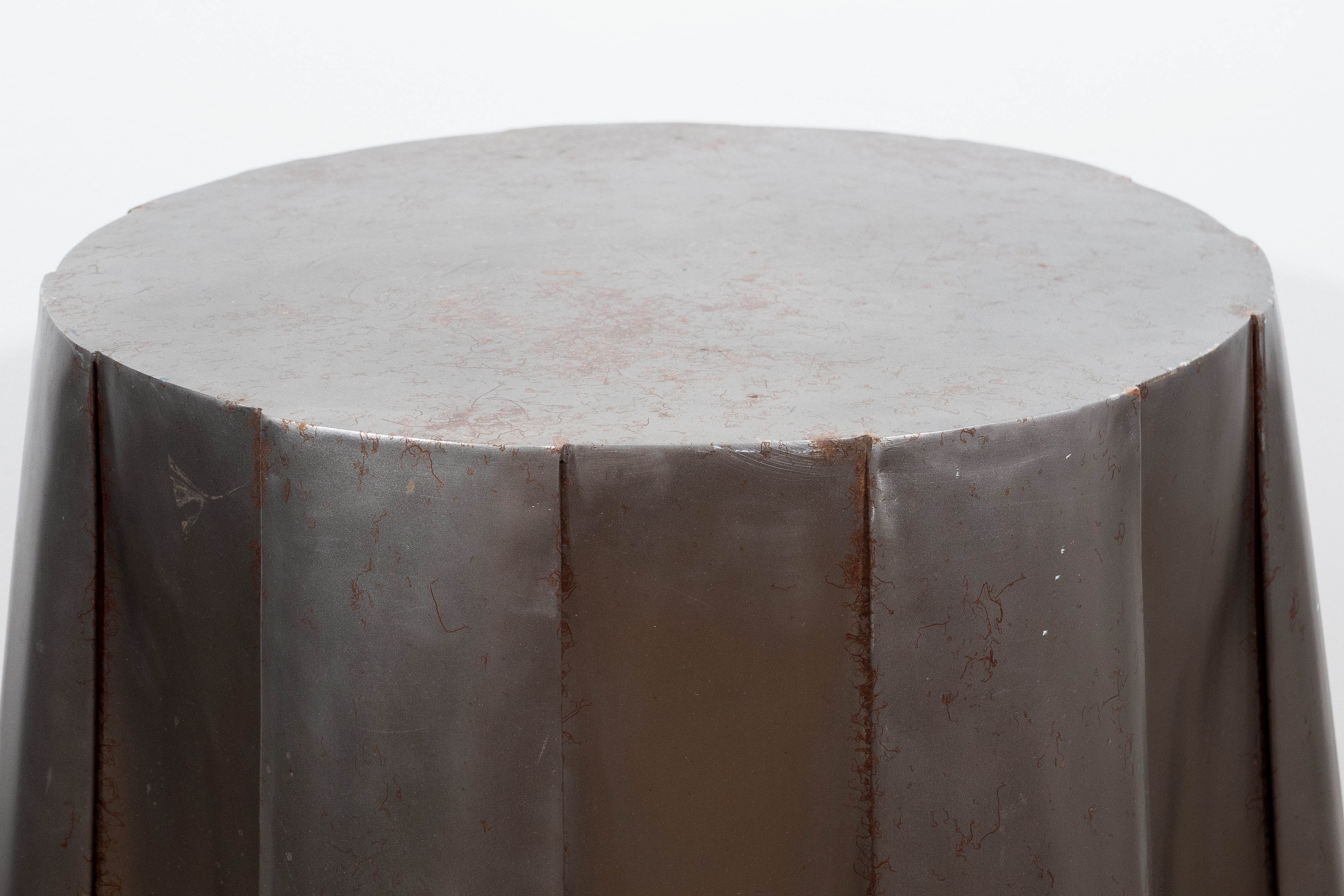 A vintage steel side table, designed in the style of John Dickinson, with galvanized tin, which imitates draped fabric, with sculptured pleats and folds, the surface finished in painted, faux patina.