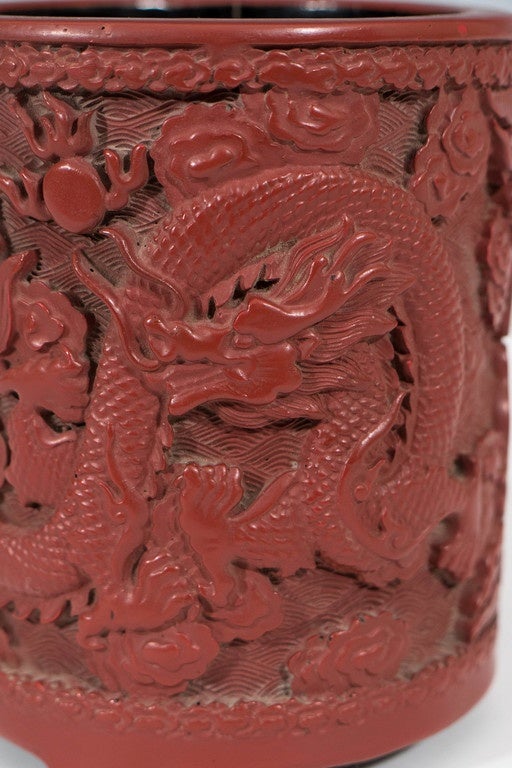 A Chinese cinnabar pot, produced within the Daoguang period (1890-1920), the body beautifully carved, detailing two celestial dragons, the interior painted in black lacquer. Markings include signature on the bottom of the piece. Very good antique