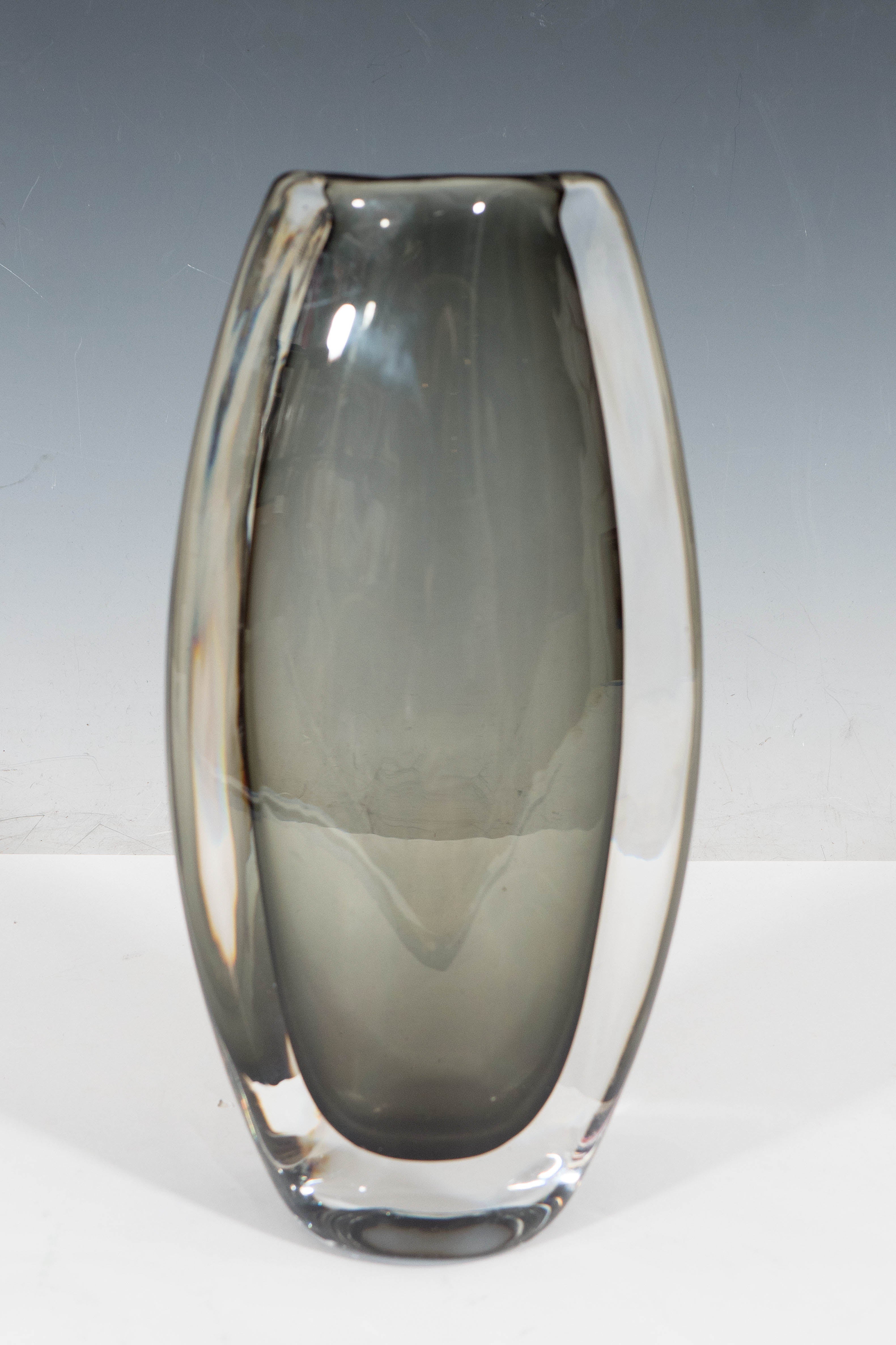 A Swedish vintage 'sommerso' glass vase, produced circa 1950's -60's by designer Nils Landberg (1907-1991) for Orrefors, with smoked charcoal interior, cased within a clear layer. Markings include etched signature on the bottom [Orrefors 3538/7],