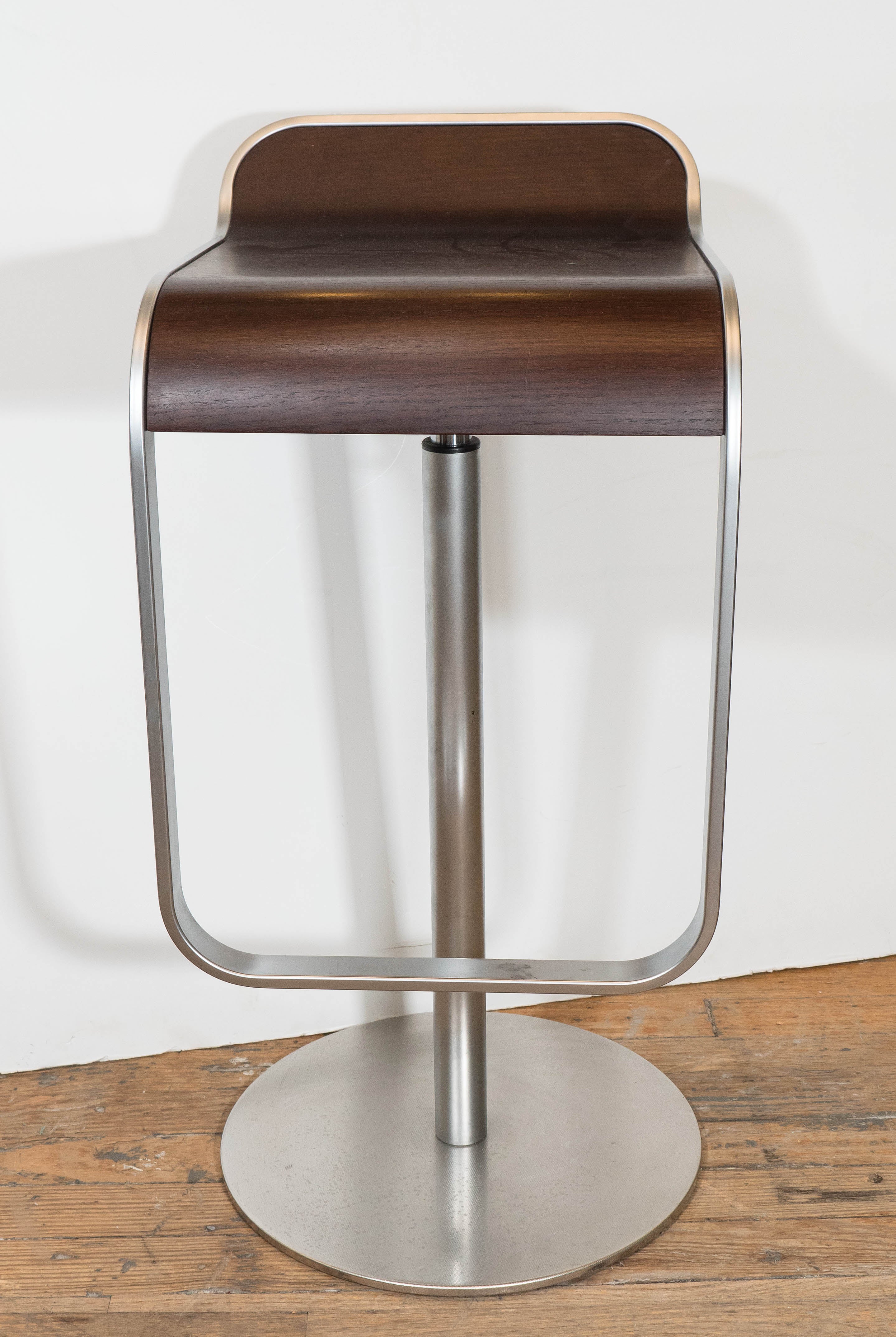 Manufactured in Italy, based on the original designs by Shin & Tomoko Azumi for La Palma, this pair of Lem Piston Barstools feature curved walnut and brushed chrome base and frame, with an adjustable height. Very good condition, consistent with age