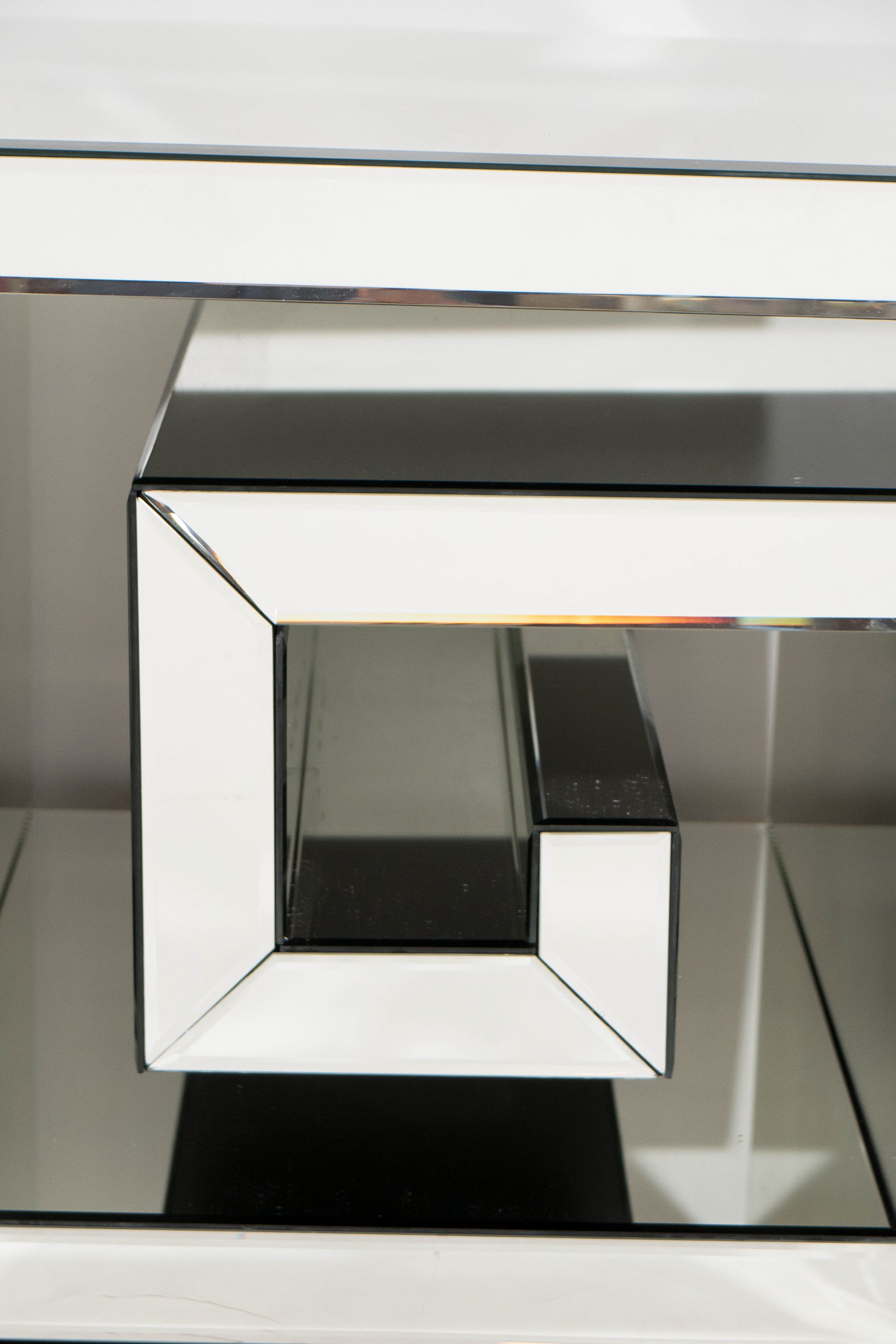 Pair of contemporary, custom mirror panel side tables, shaped as Greek keys, in the manner of Gucci. In good condition, consistent with age and use.