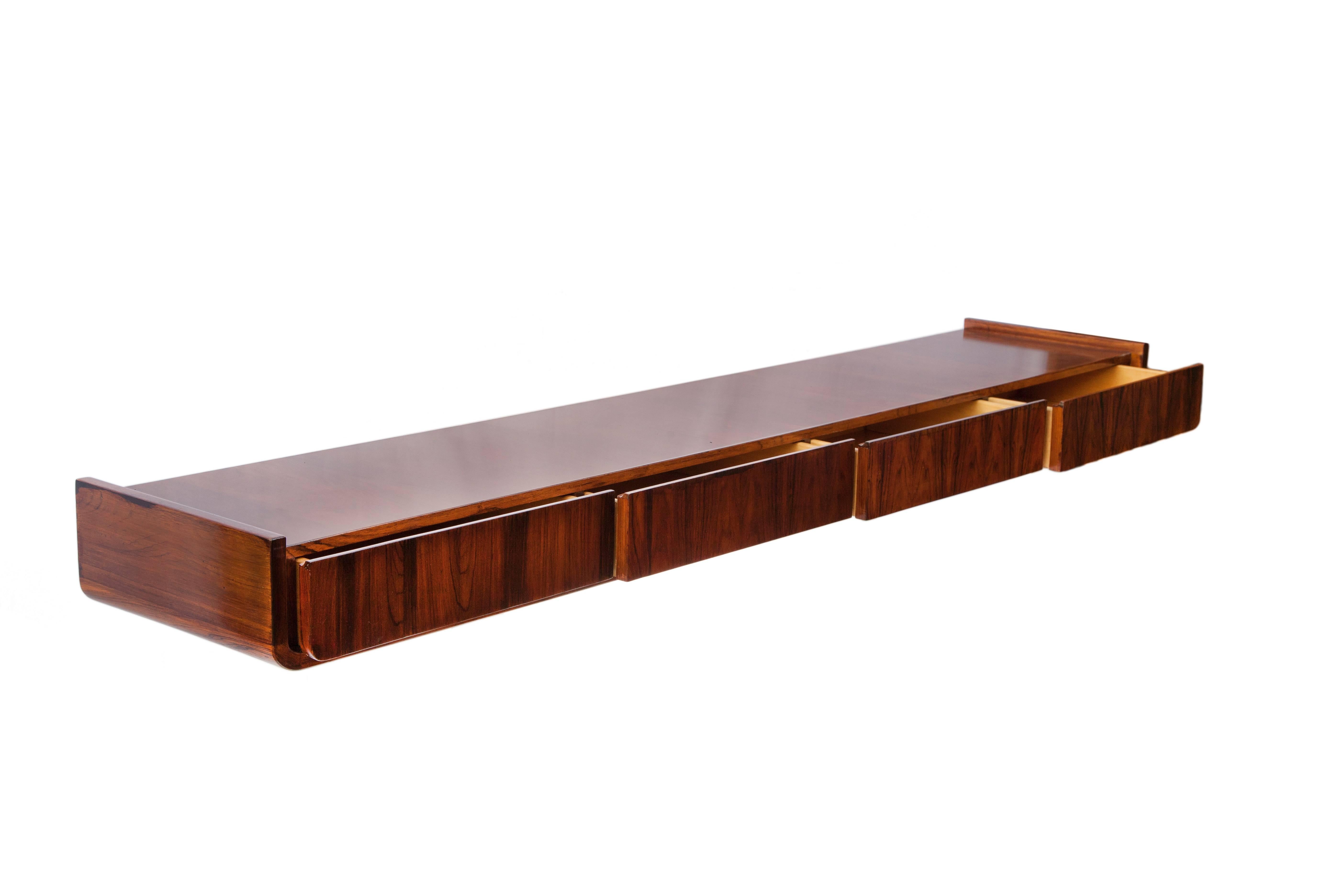 Mid-Century Modern wall console, produced circa 1960s in Brazilian jacaranda wood, with four exterior drawers. Good vintage condition, with age appropriate wear.