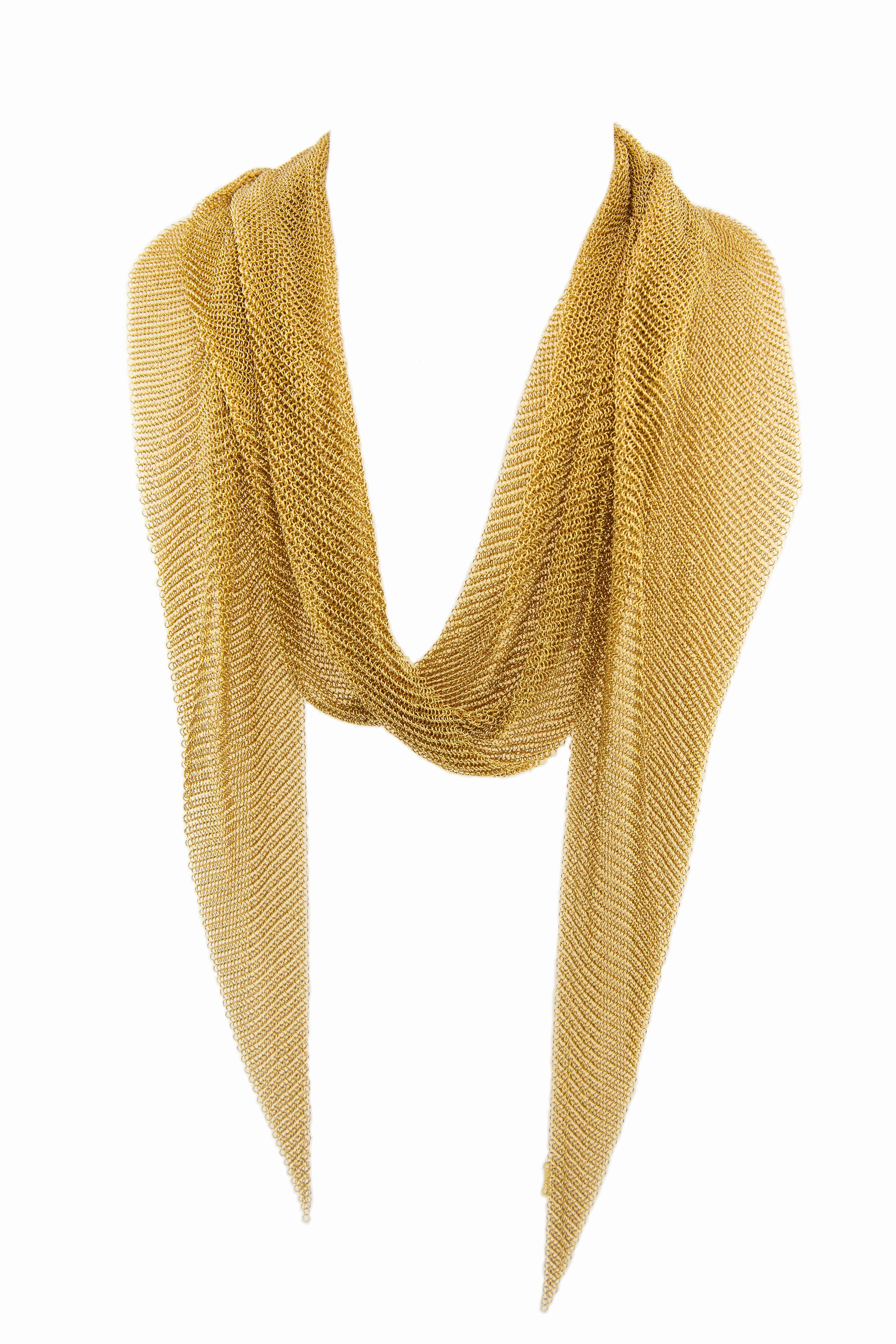 A contemporary mesh scarf and necklace in genuine 18k gold, designed by Tiffany & Co. and Italian jewelry designer Elsa Peretti (b. 1940-). Peretti, whose collaborations with Tiffany & Co. began as early as 1974, was inspired by the movement and