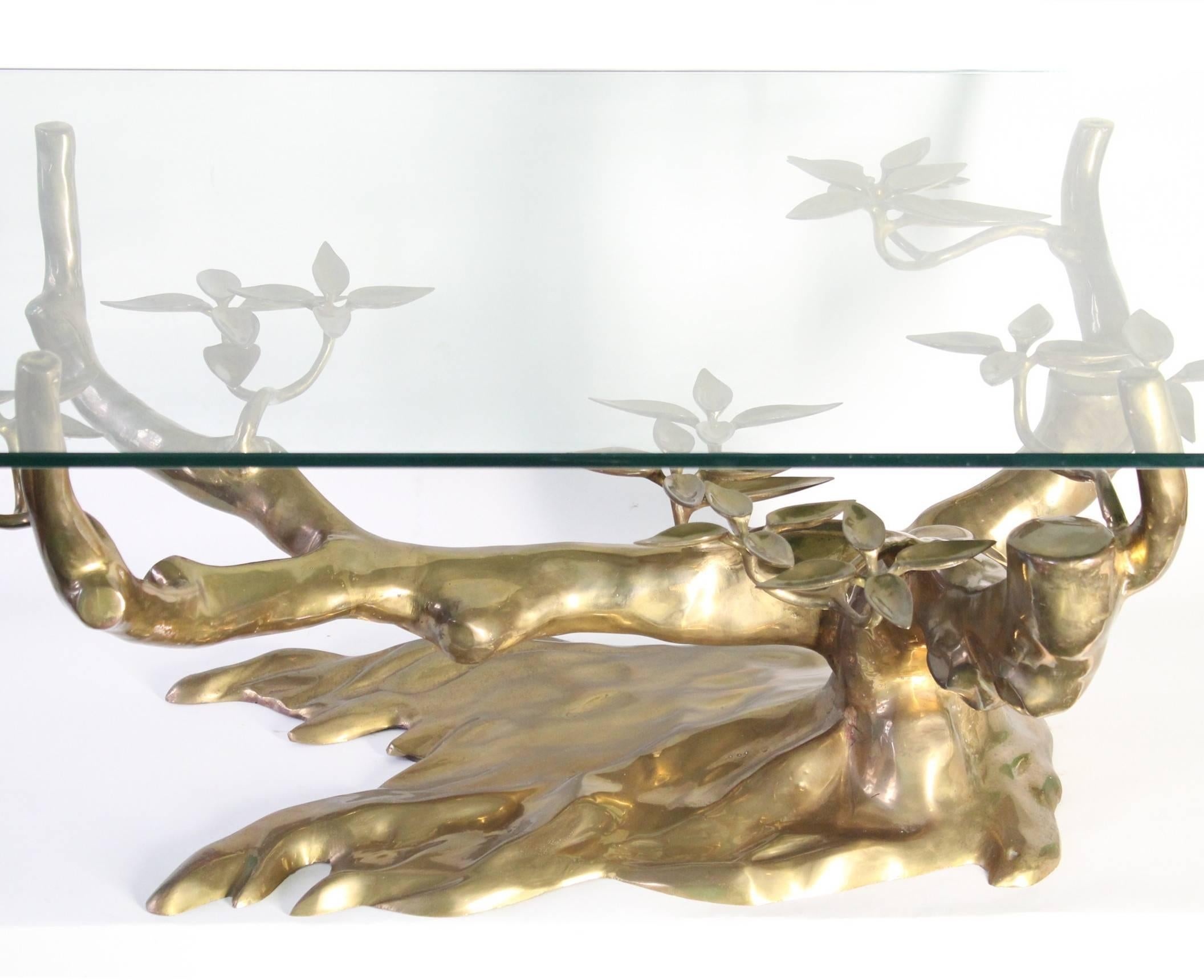This highly sculptural coffee table features a brass bonsai tree as base, with beautifully gnarled branches and foliage; dimensions reflect inclusion of glass top. Good condition, consistent with age and prior use.

9390