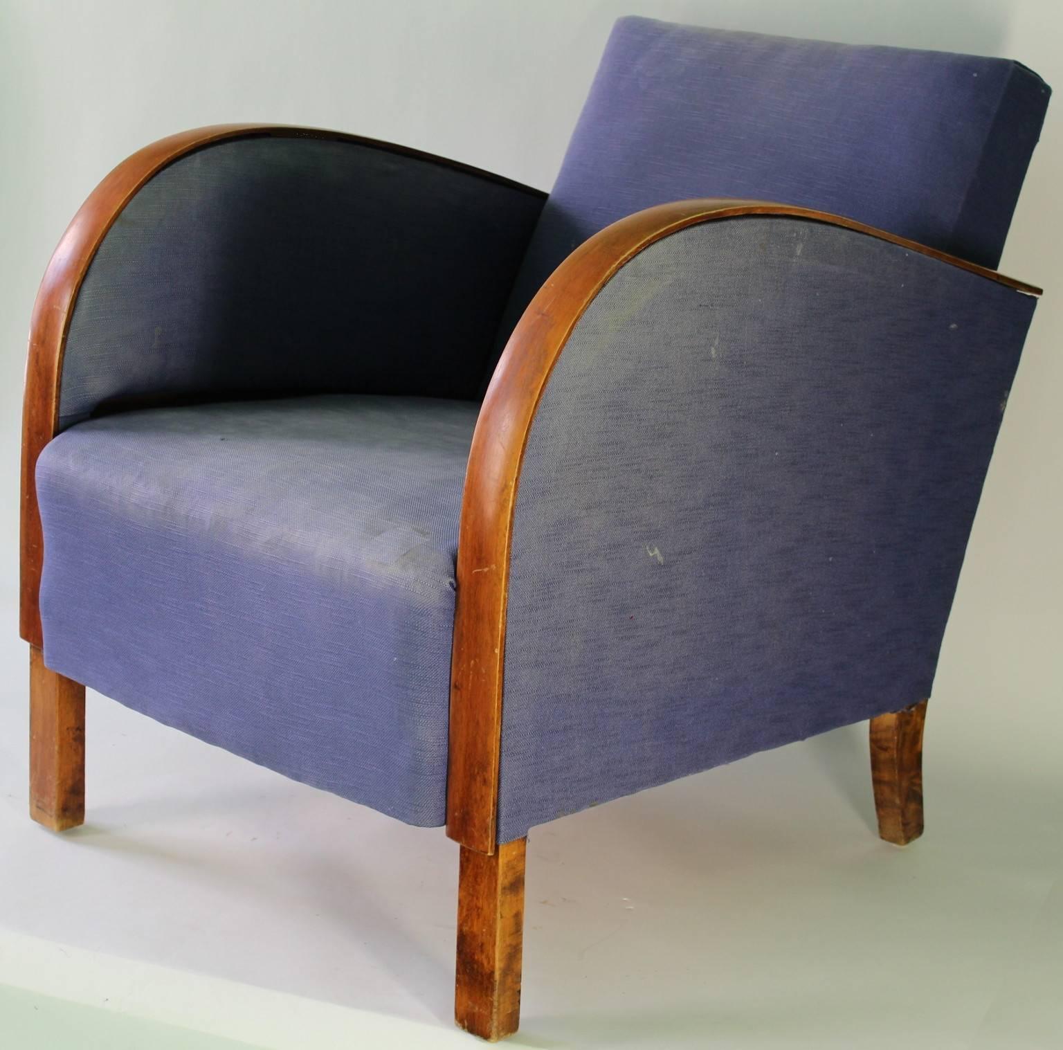 A pair of vintage, Art Deco club armchairs from the 1930s, back and seat upholstered in original blue fabric, with curved armrests on slanted legs. Fair vintage condition, with age appropriate wear; requires new upholstery.

9388