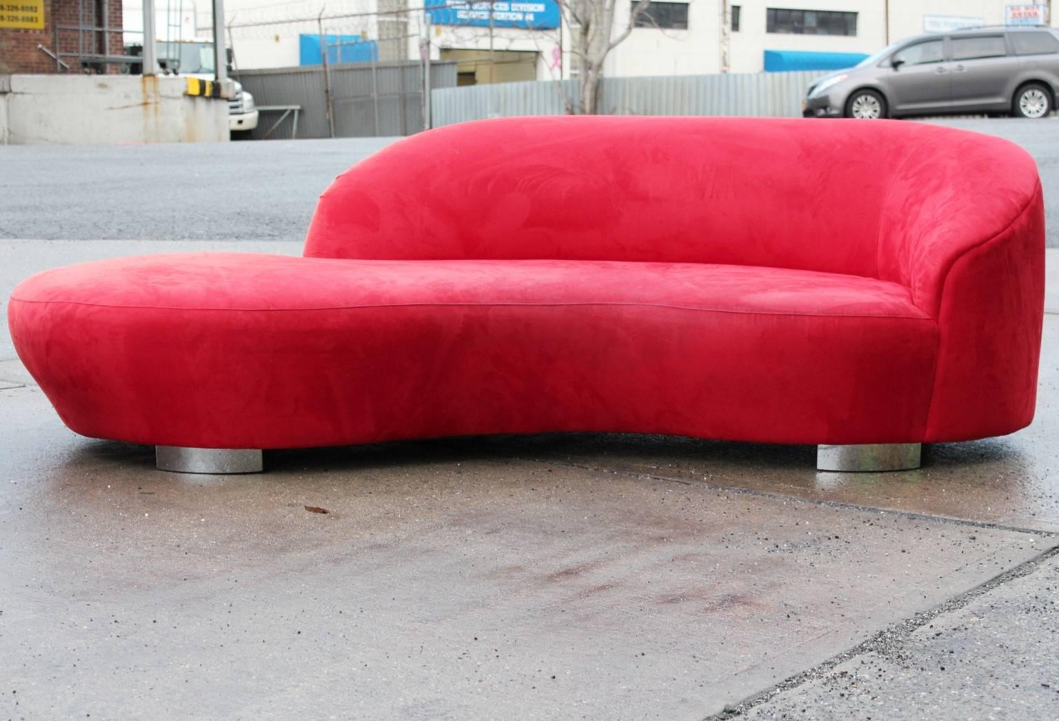 A 'Cloud' sofa, by designer Vladimir Kagan and produced circa 1980s, entirely in red ultrasuede on chrome plated steel base, with curved back, designated to one side of the sofa, facing right. Overall good condition, with some wear, consistent with