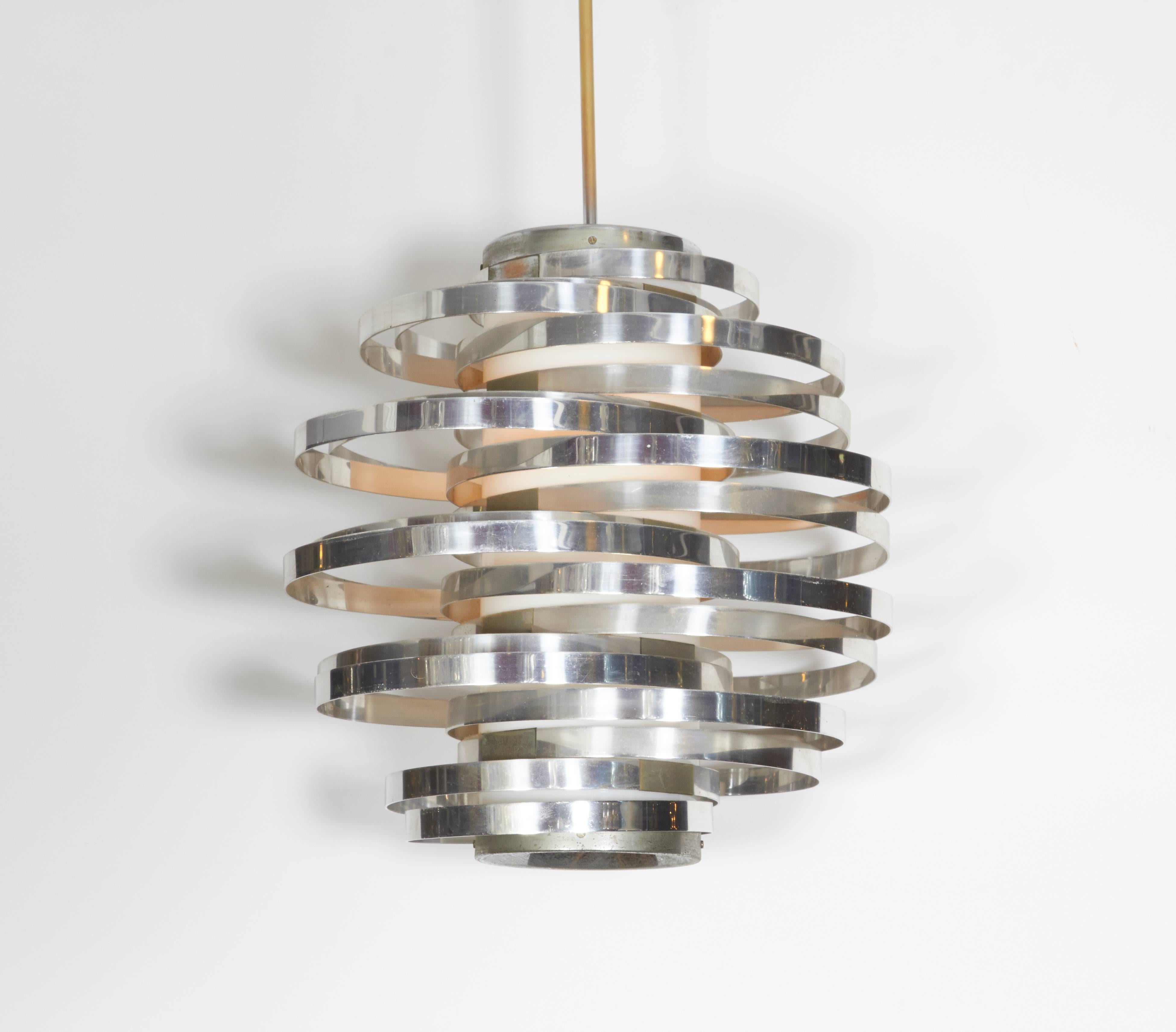 This Italian, circa 1960s pendant chandelier, designed by Max Sauze for Sciolari, comes with central plexiglass cylinder, encircled by syncopated bands of polished aluminium. Wiring and socket to US standard. Dimensions provided reflect body. This