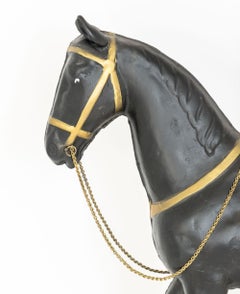 Girouette en métal doré et ébonisé représentant un cheval de manège américain