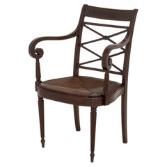 Fauteuil en acajou de style Régence, avec incrustations en cordons sur les accoudoirs en volutes