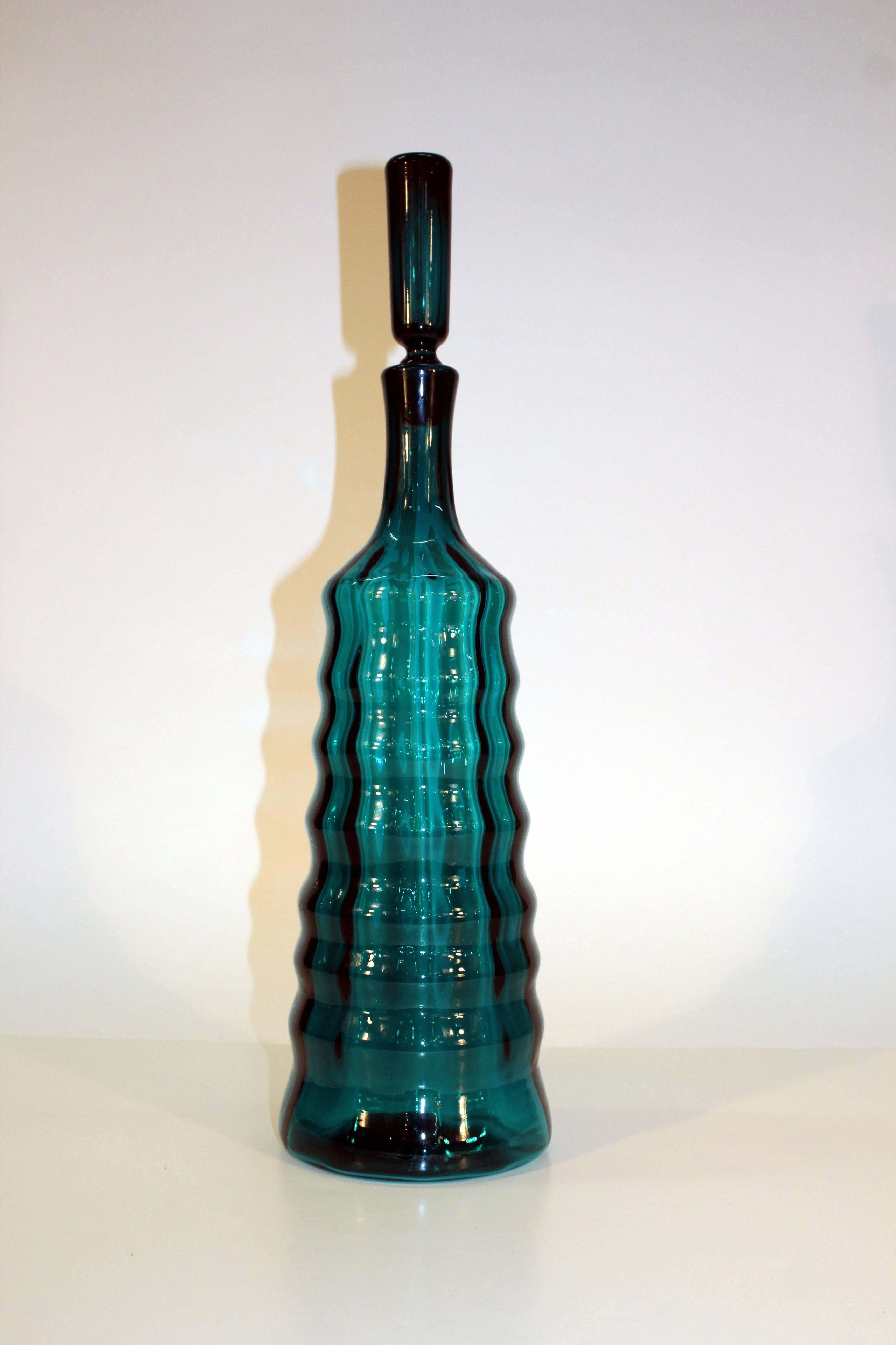 A "L" decanter designed in 1965 for Blenko Glass Co. by Joel Myers, in a vibrant peacock blue. Crafted in Milton, West Virginia and numbered.

110230