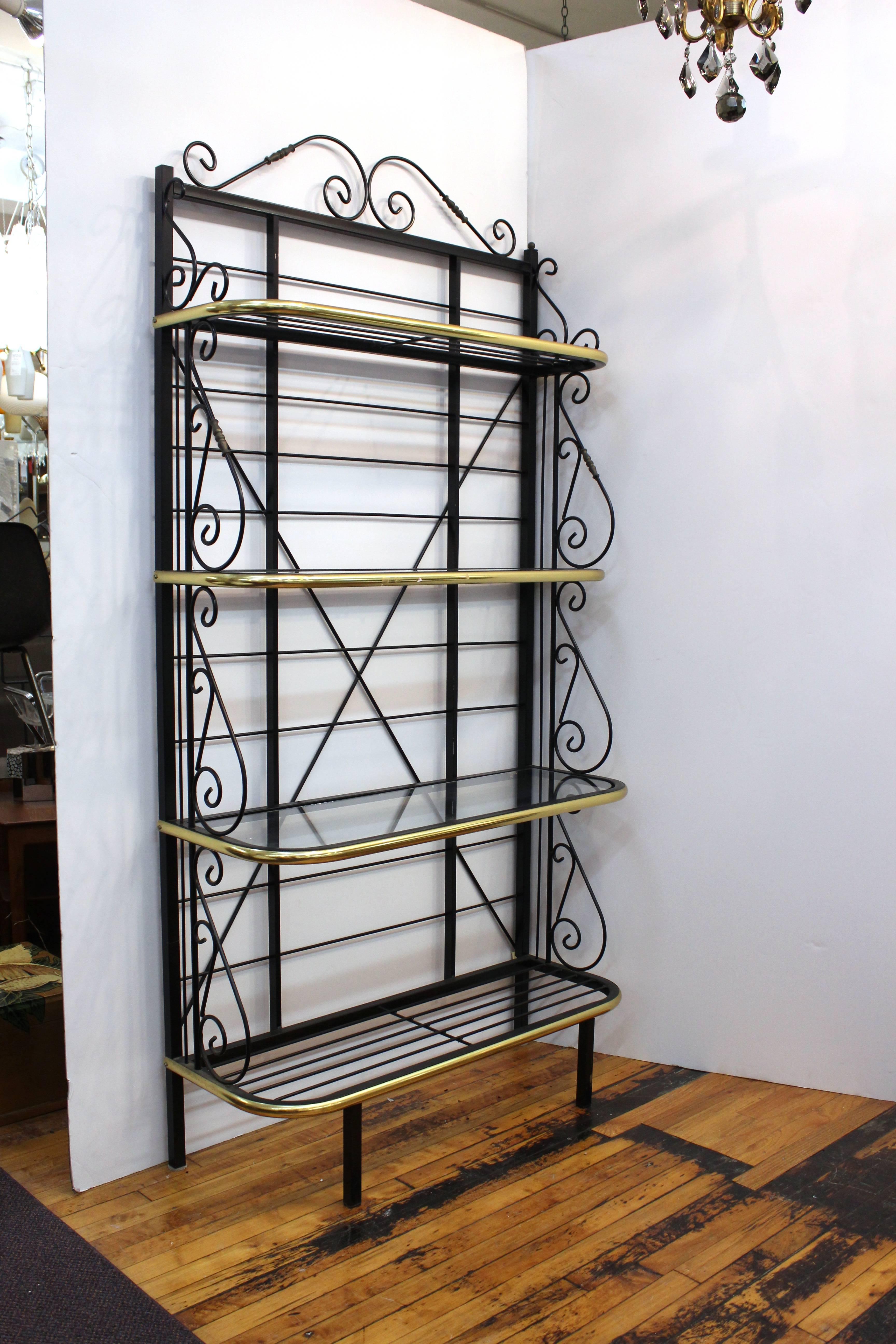 A bakers rack produced in metal and brass during the 1970s. Includes four shelves, two glass and two metal.

 