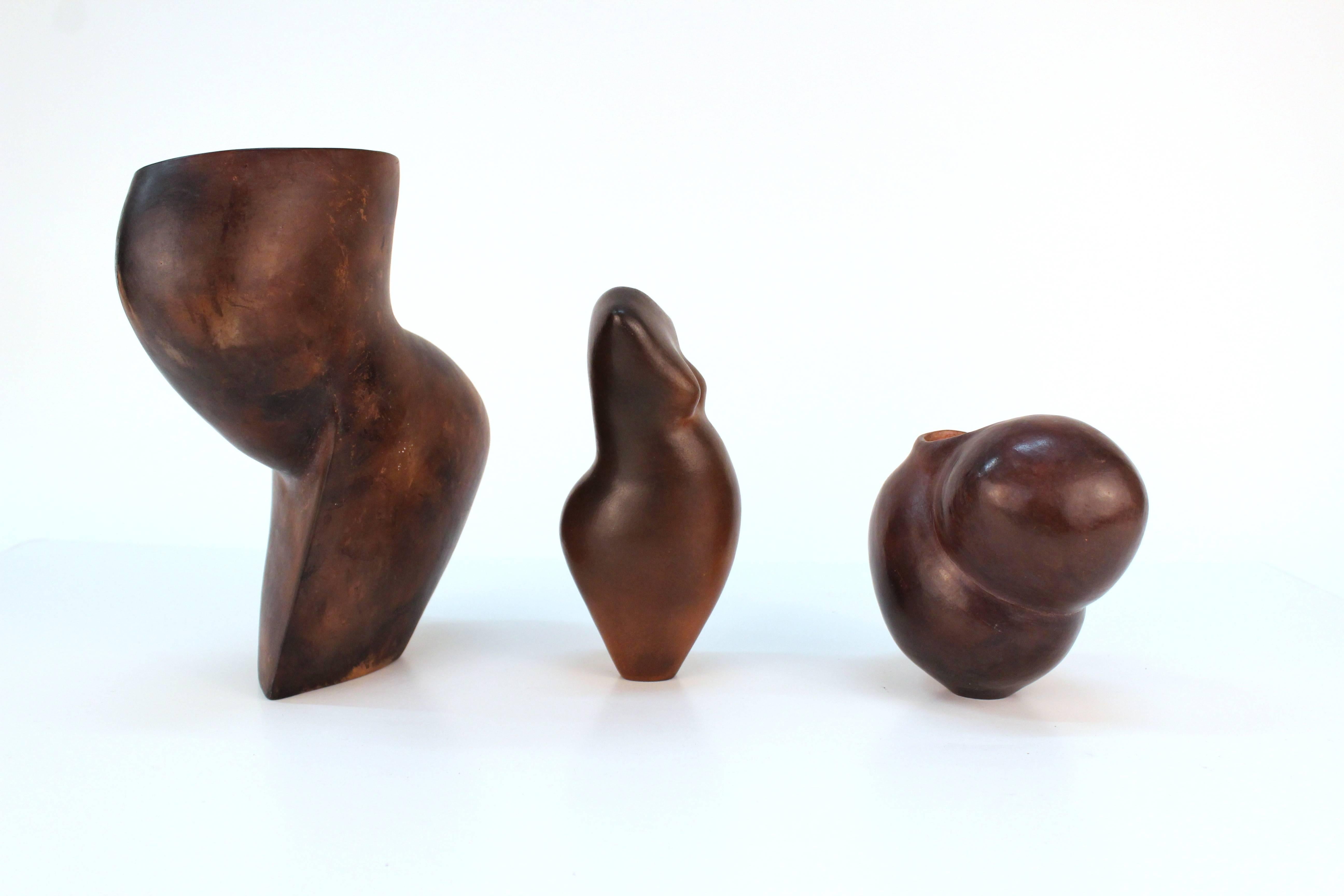 A collection of several sculptural ceramic vases by Louise Black. Available as a group or individually.

Louise Black torso vase 
Measures: 3 inch. D x 2.5 inch. W x 6.5 inch. H 
$250

Louise Black vase with two organic bulbs 
Measures: 3