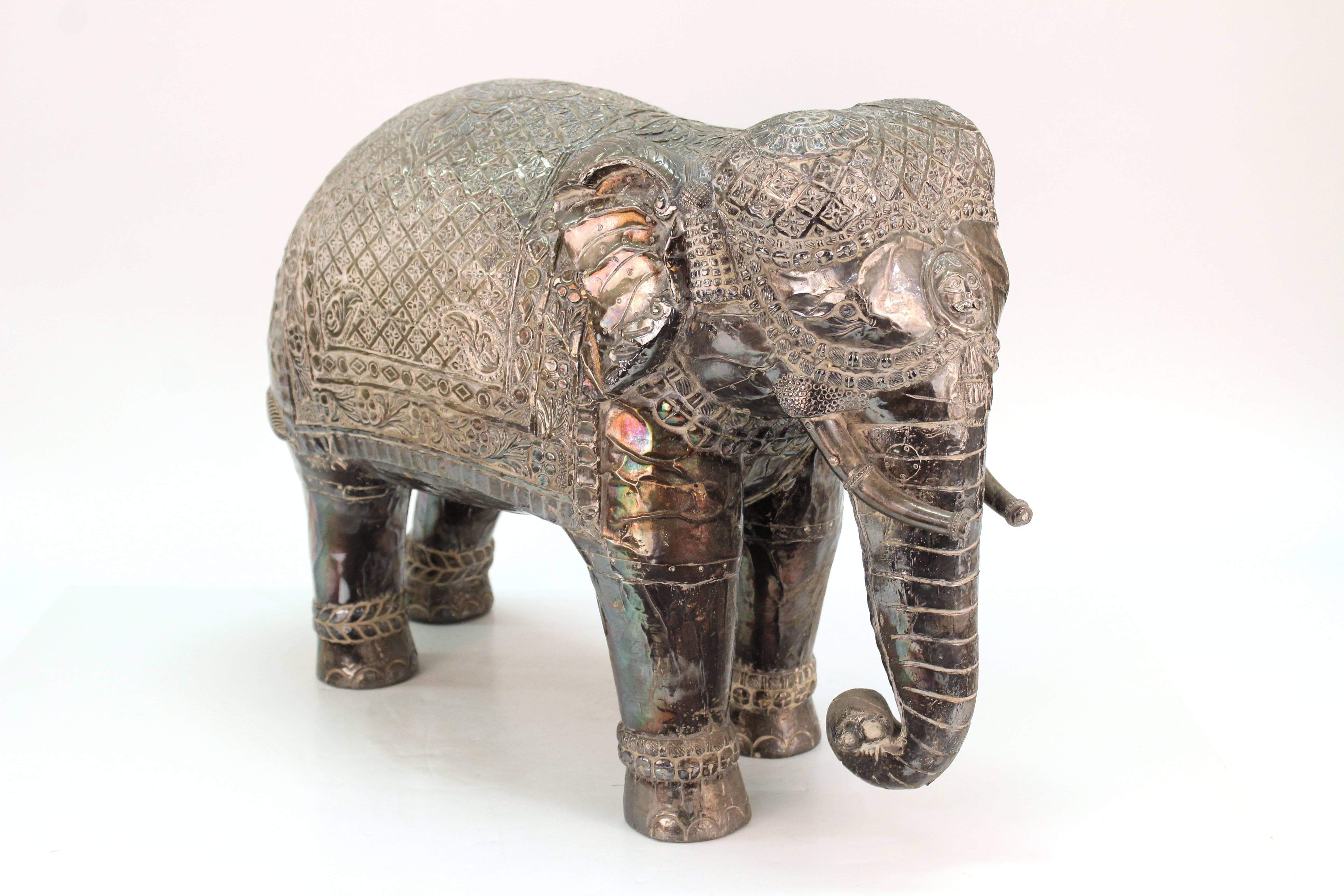 Pair of Mid-Century period sculptures of Indian elephants, silver sheet covering with highly detailed embossing. Good vintage condition with age appropriate wear.

110377
