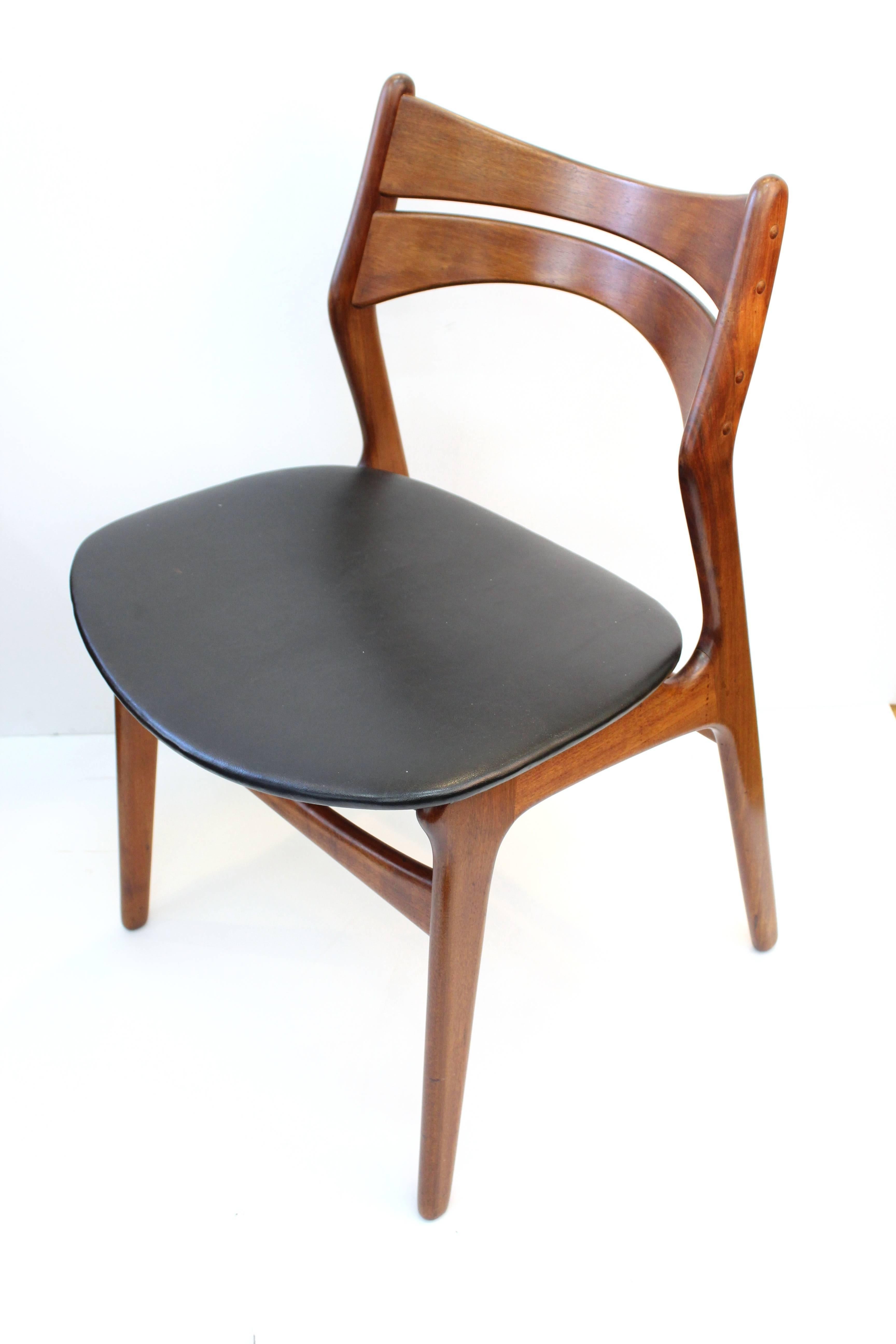 Set of dining chairs designed by Erik Buck for Chr. Christiansen in the 1950s. Includes six dining chairs, two with arms and a makers mark on the bottom. The chairs have some wear appropriate to age and use but are in overall good condition.