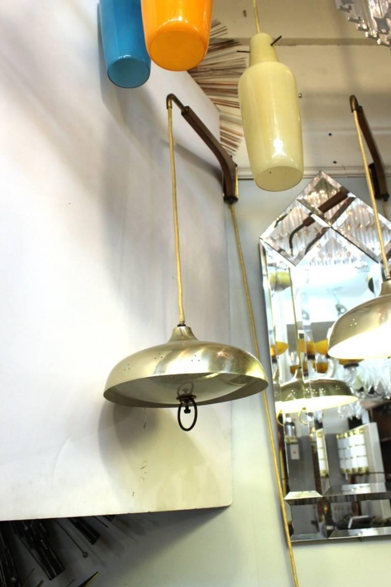 These pendants are crafted in polished brass with a wooden attachment to a wall. In great vintage condition.