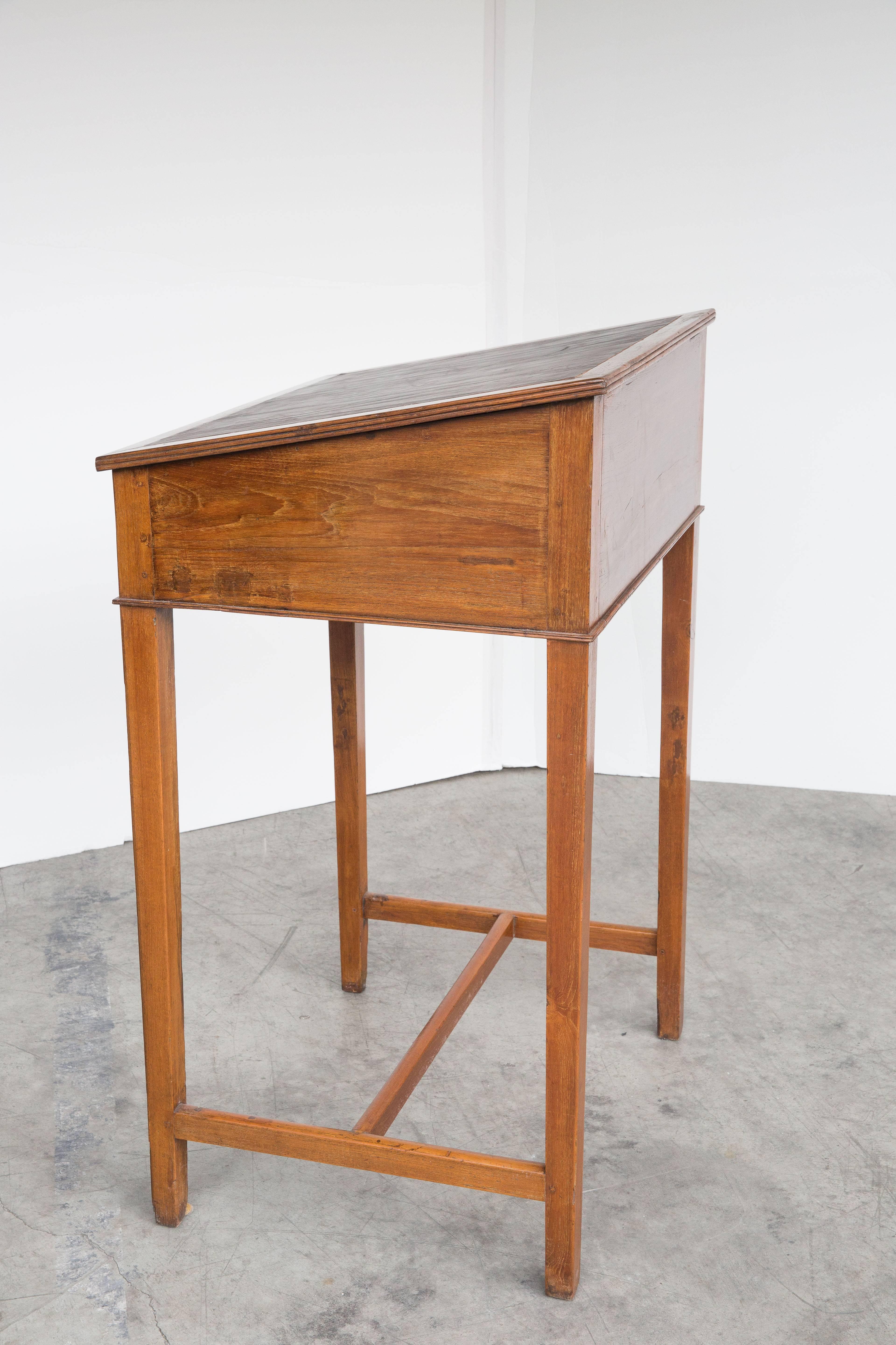 Anglo-Indian tall scribes desk made of solid teak. Top lifts up to reveal compartment for document storage. Inset leather top. Perfect for a restaurant!
