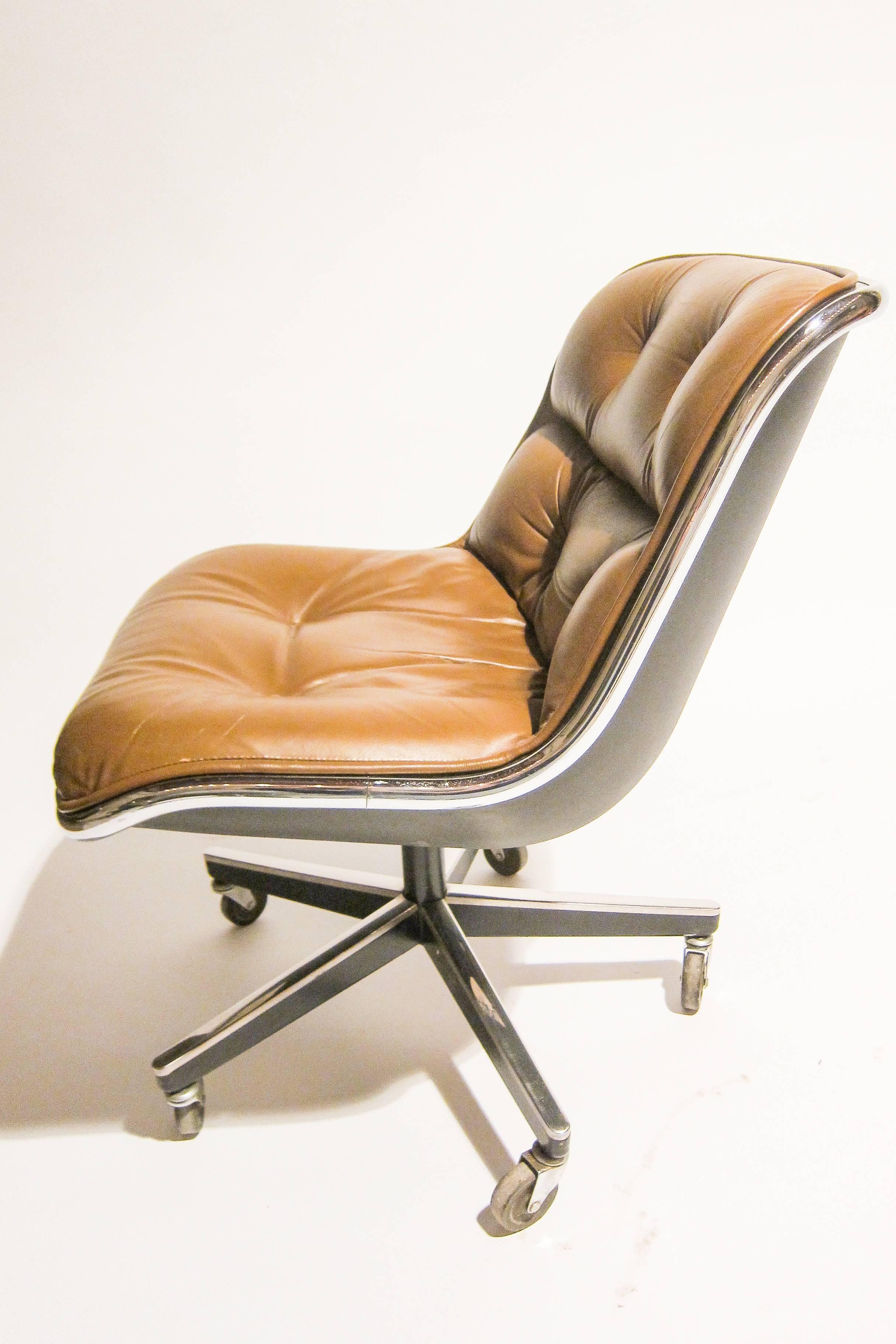 Leather executive or dining chair by Charles Pollock for Knoll International. 

Structured out of a chrome rim that gives the chair support and aesthetic appeal. The tufted tan leather with padding makes for a comfortable experience. There are