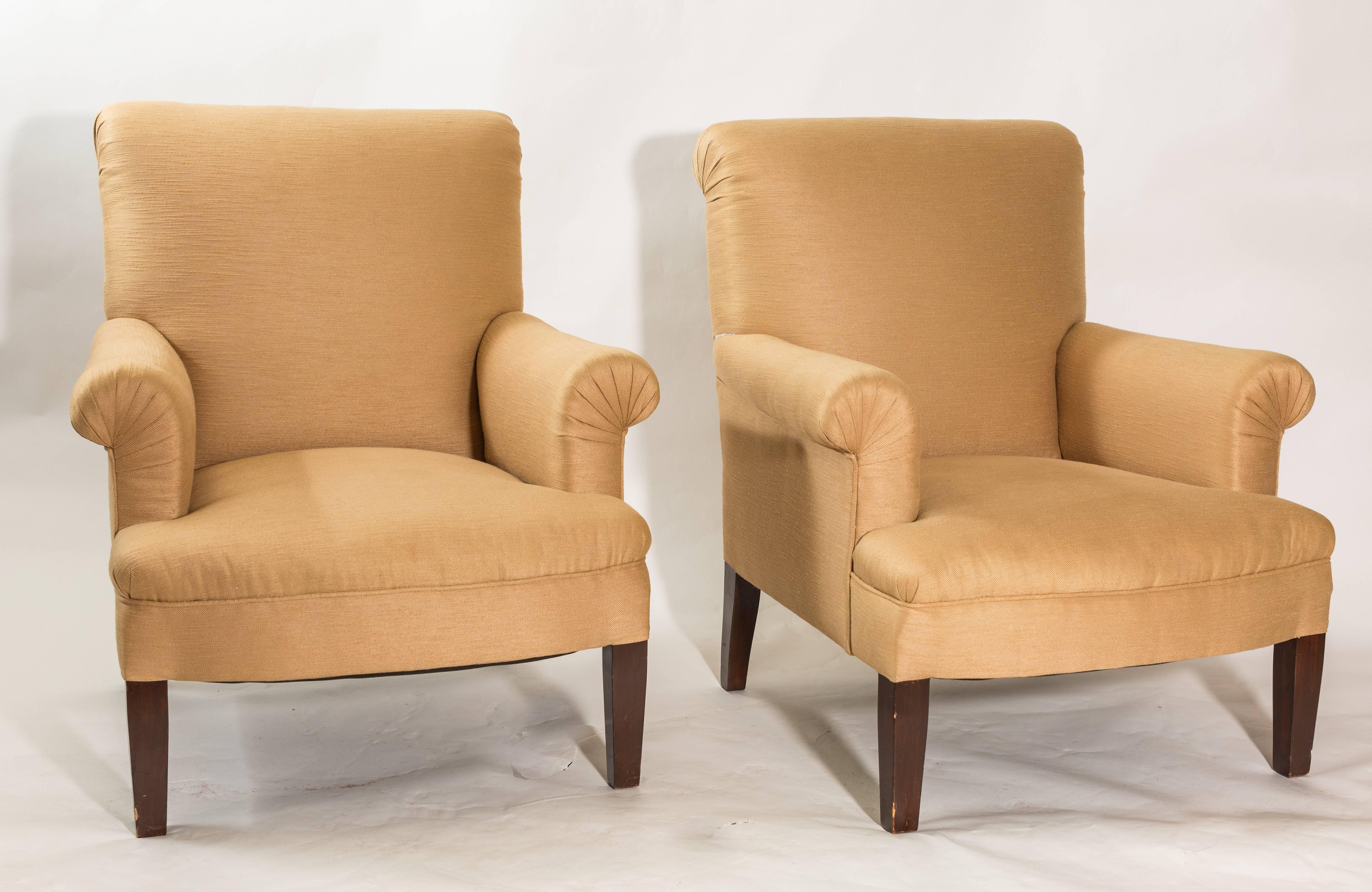 Pair of lovely Baker armchairs, sit lower to ground. Rich beige linen in color with a fanned rouche arm finish. Tapered Mid-Century Modern legs.