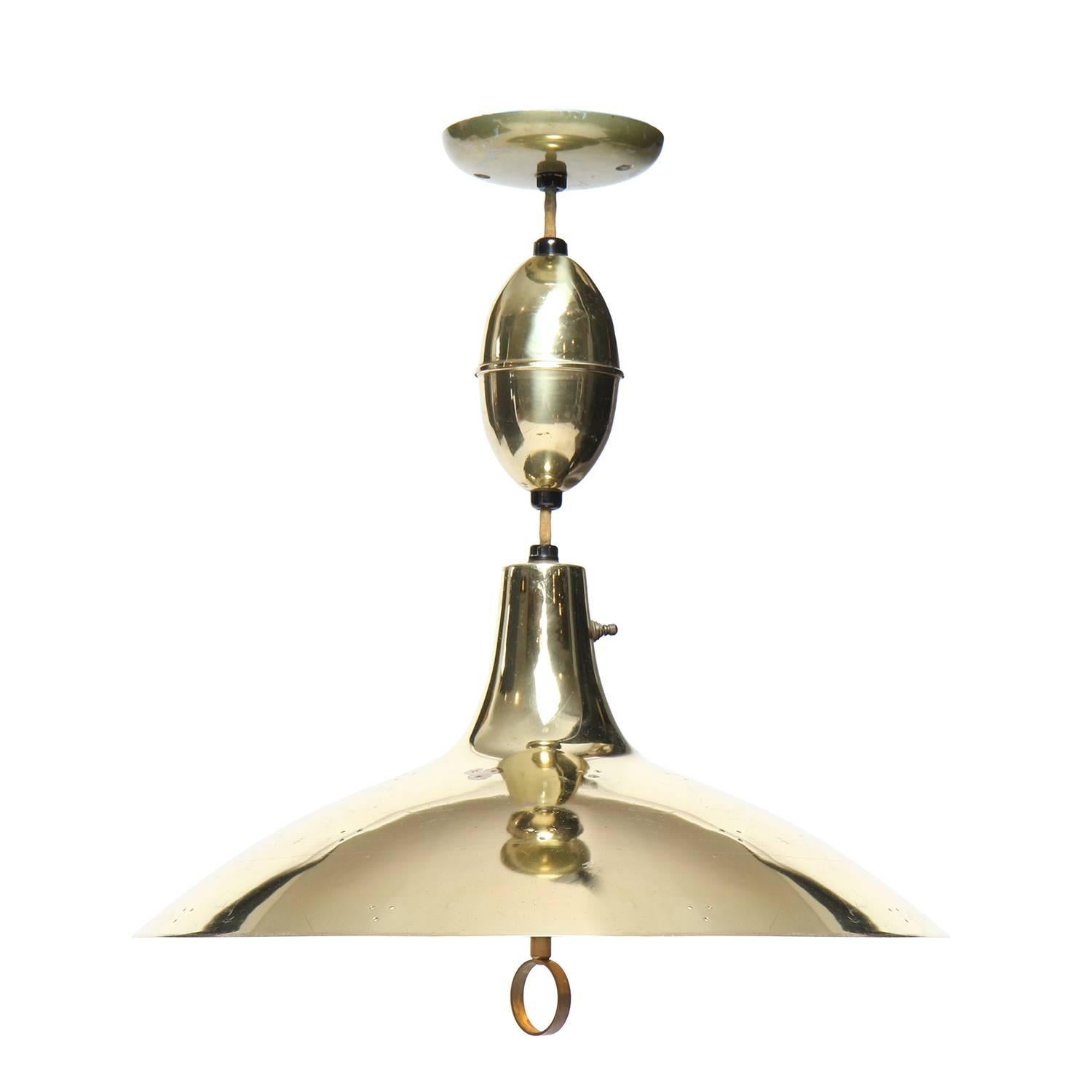 A fine brass adjustable ceiling fixture having a perforated dome shade and ring handle.