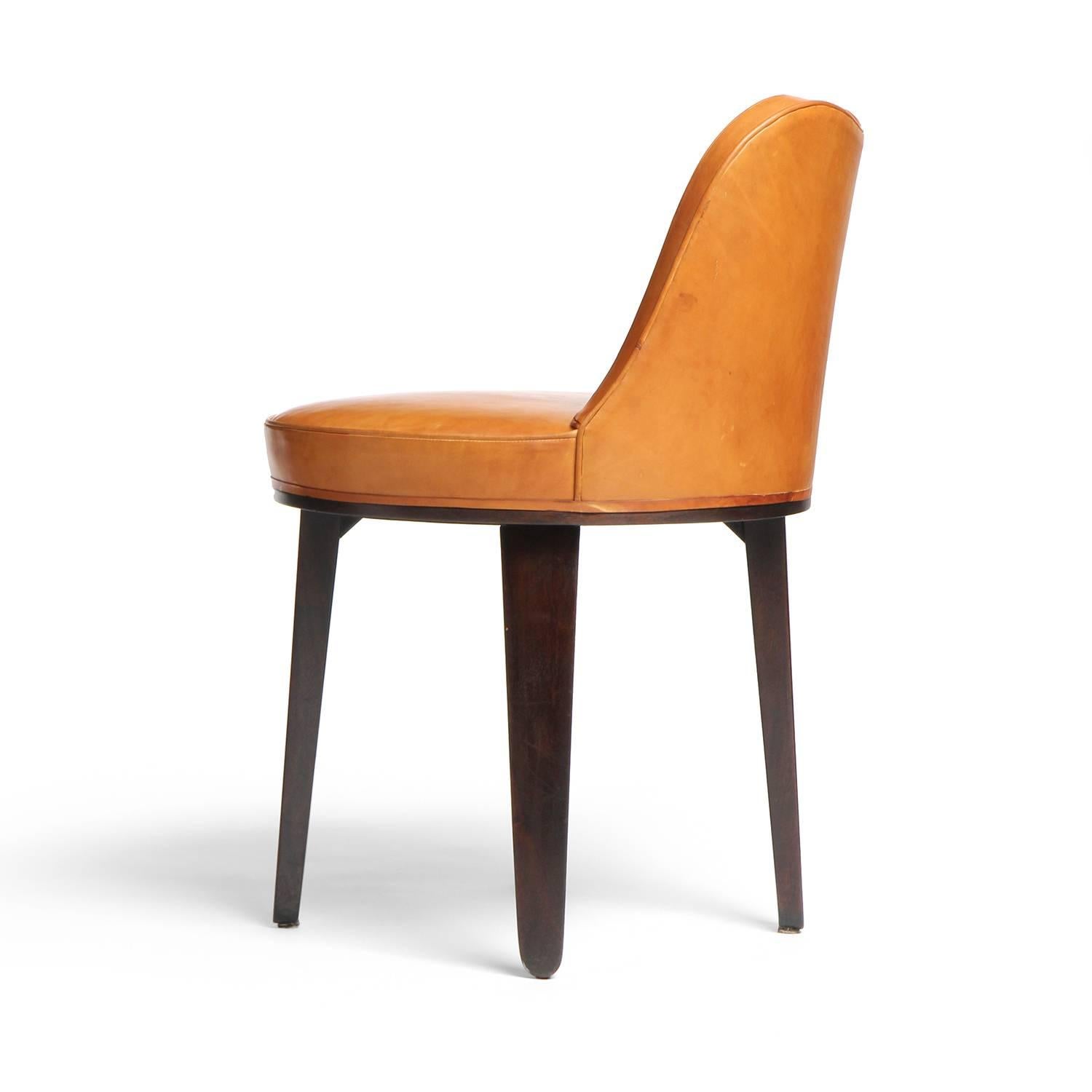 A small sway backed swivel chair with shapely tapered mahogany legs.