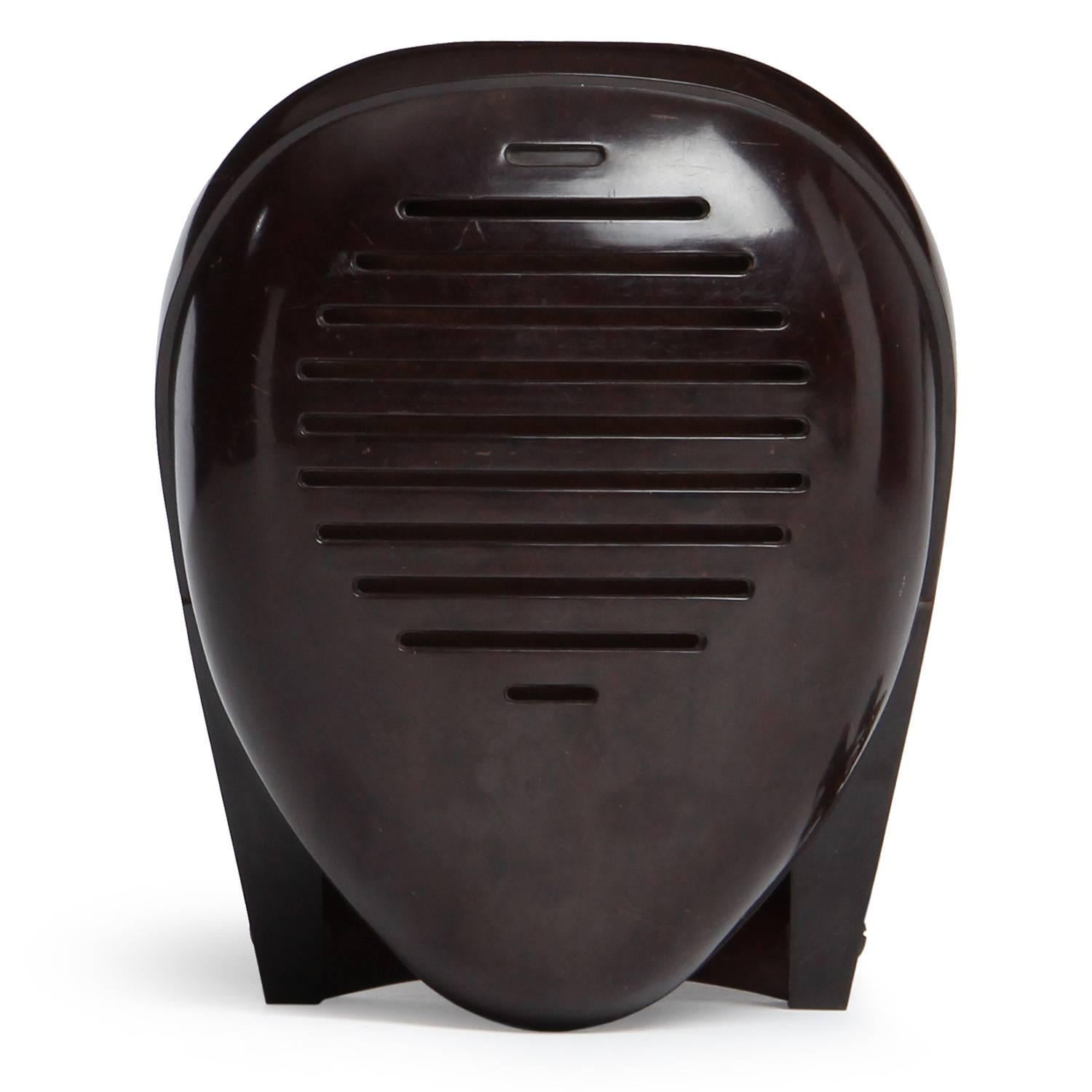 A highly expressive baby monitor designed by the artist Isamu Noguchi in bakelite, its modernist form evocative of an abstracted human head and traditional Japanese Kendo masks.
