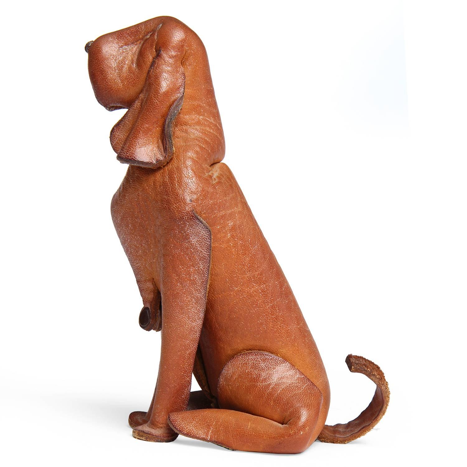 A soulful hound dog crafted from a single sheet of crimped, pinched, cut and riveted leather.