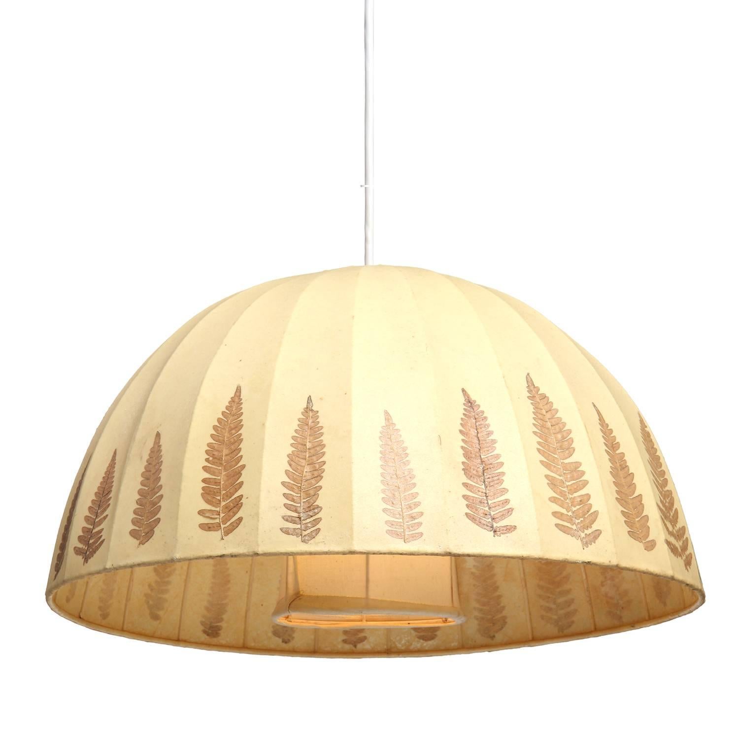 An expressive domed hanging fixture with foliate decoration.