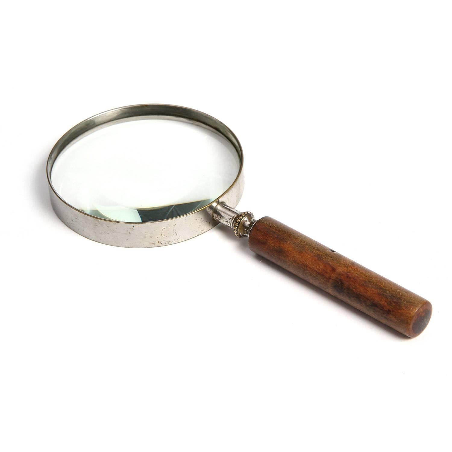 A fine and early optical quality desk top magnifying glass in nickeled brass and walnut.