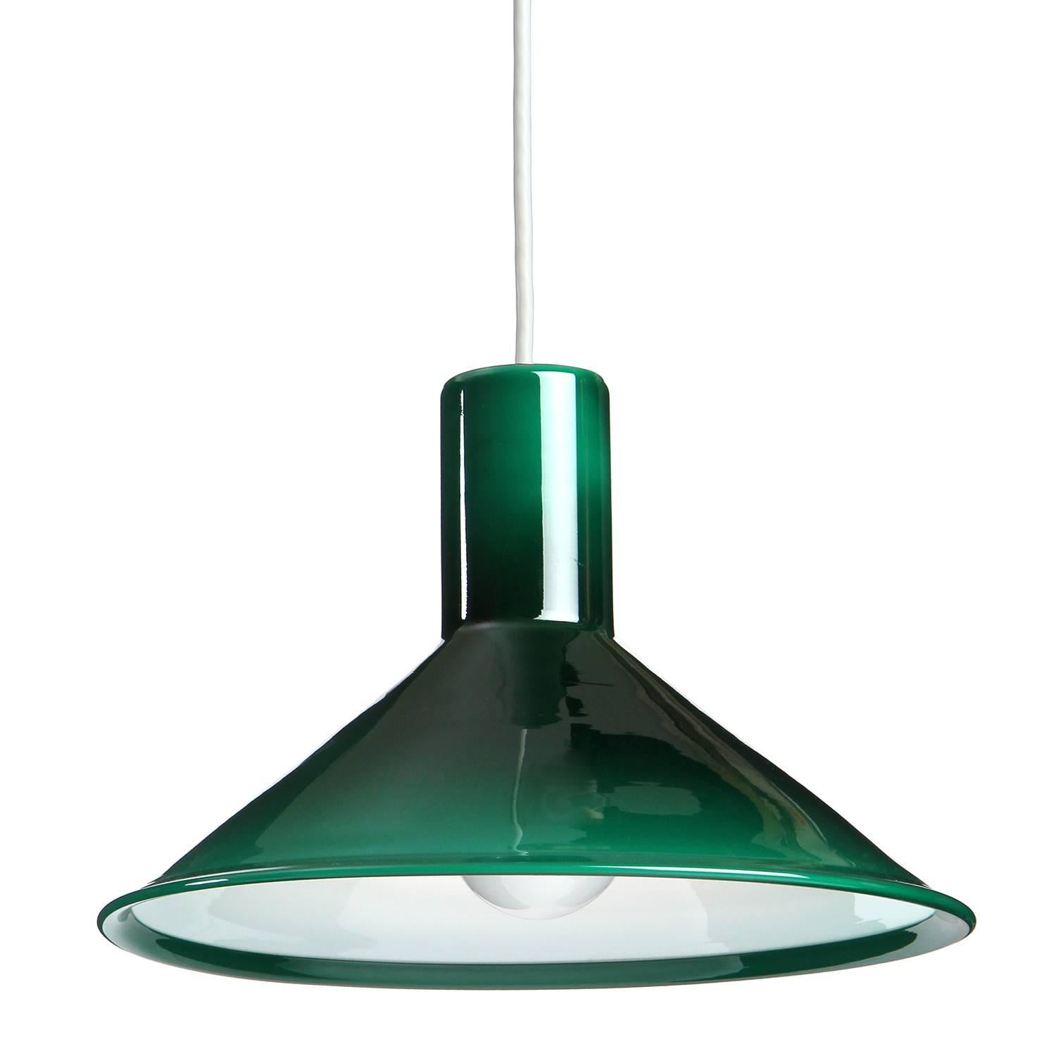 An expressive and geometric hanging pendant made of deep green glass with a white cased interior.