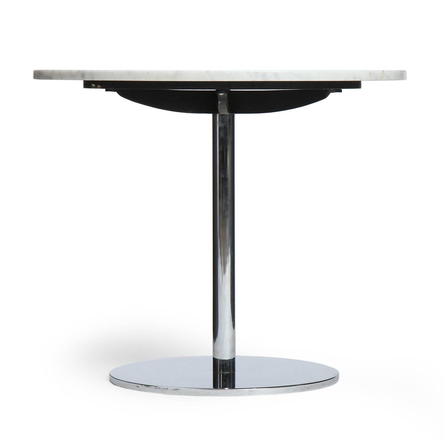 A minimalist and finely crafted occasional table having a heavy chromed steel base supporting a floating round figured marble top.