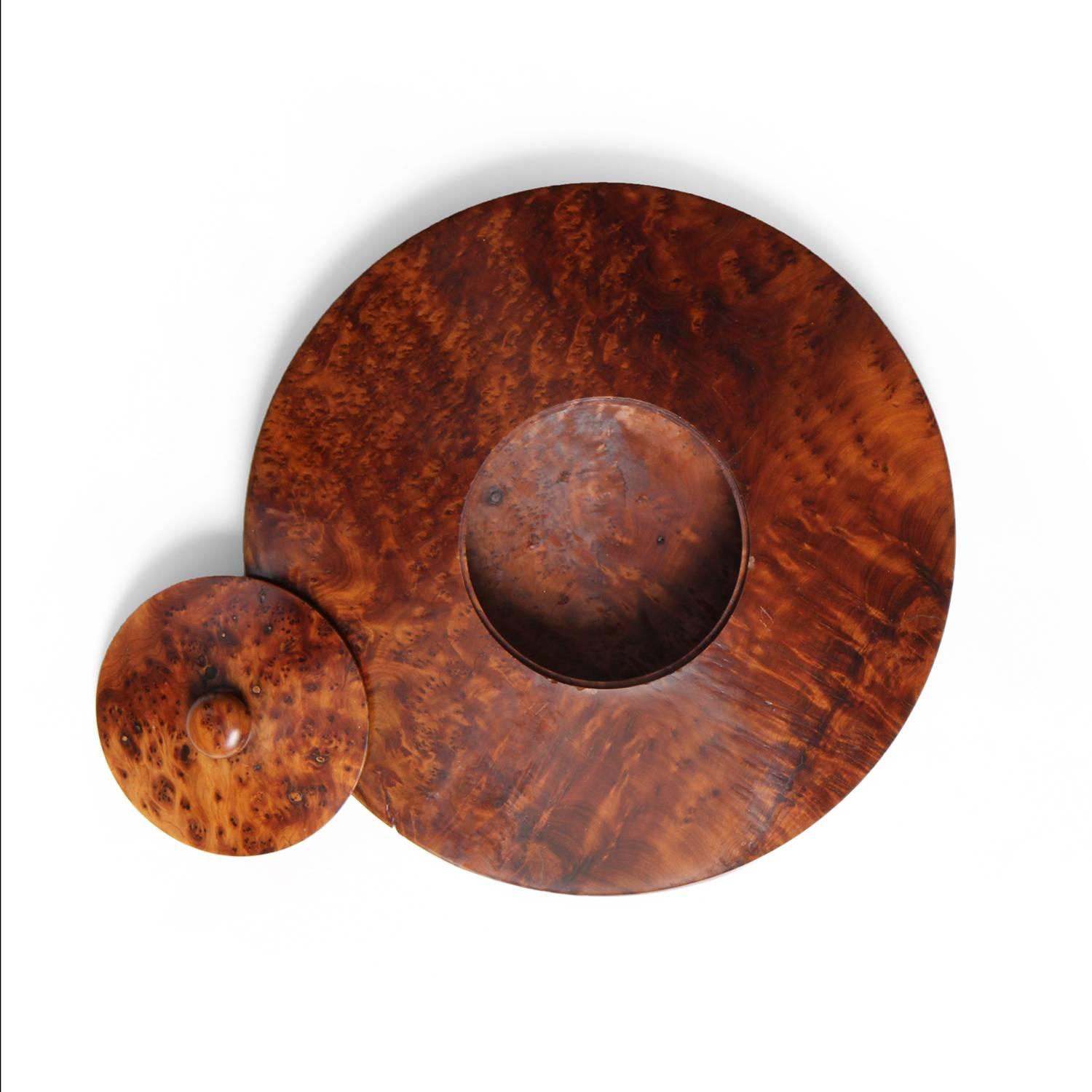 An incredible and highly expressive hollowed artist made lidded vessel having a precision flattened ovoid form and crafted of dramatically figured caramel-toned birch burl.