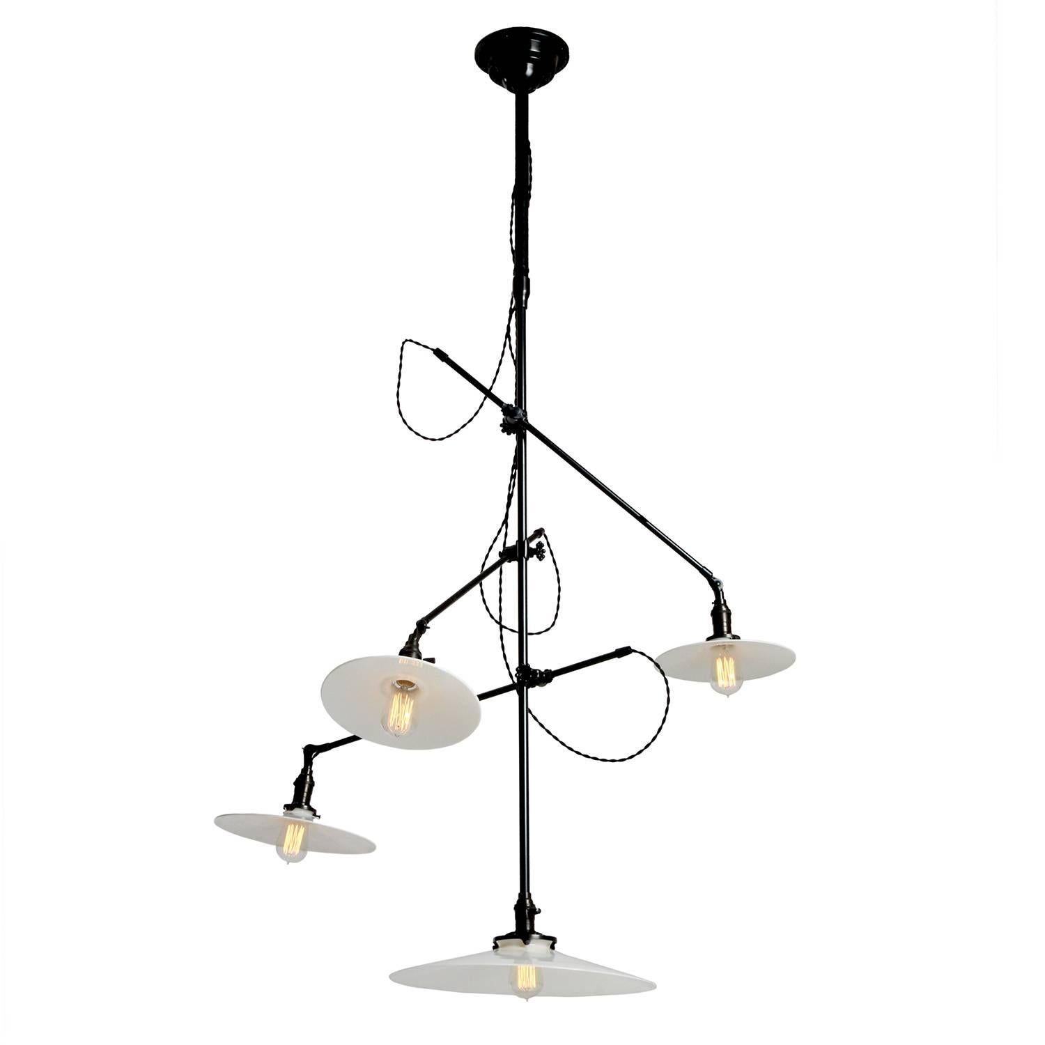 A superb Industrial ceiling-mount light fixture having three adjustable arms projecting from a central stem with down light. Signed on ceiling rosette, this fixture has a dark patinated finish and the original vintage milk glass disk shades with