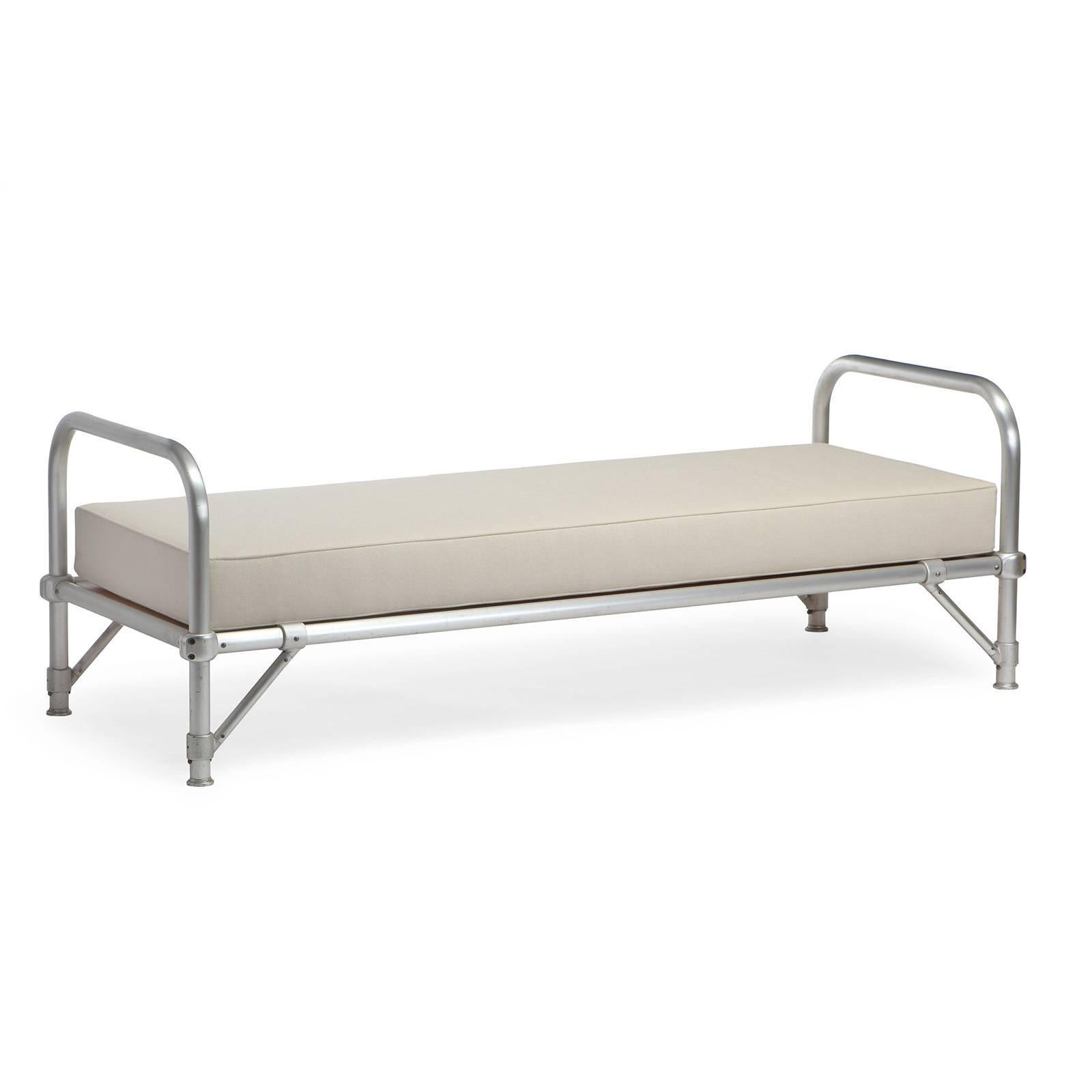 A well crafted army cot or daybed having an anodized tubular aluminum frame. 