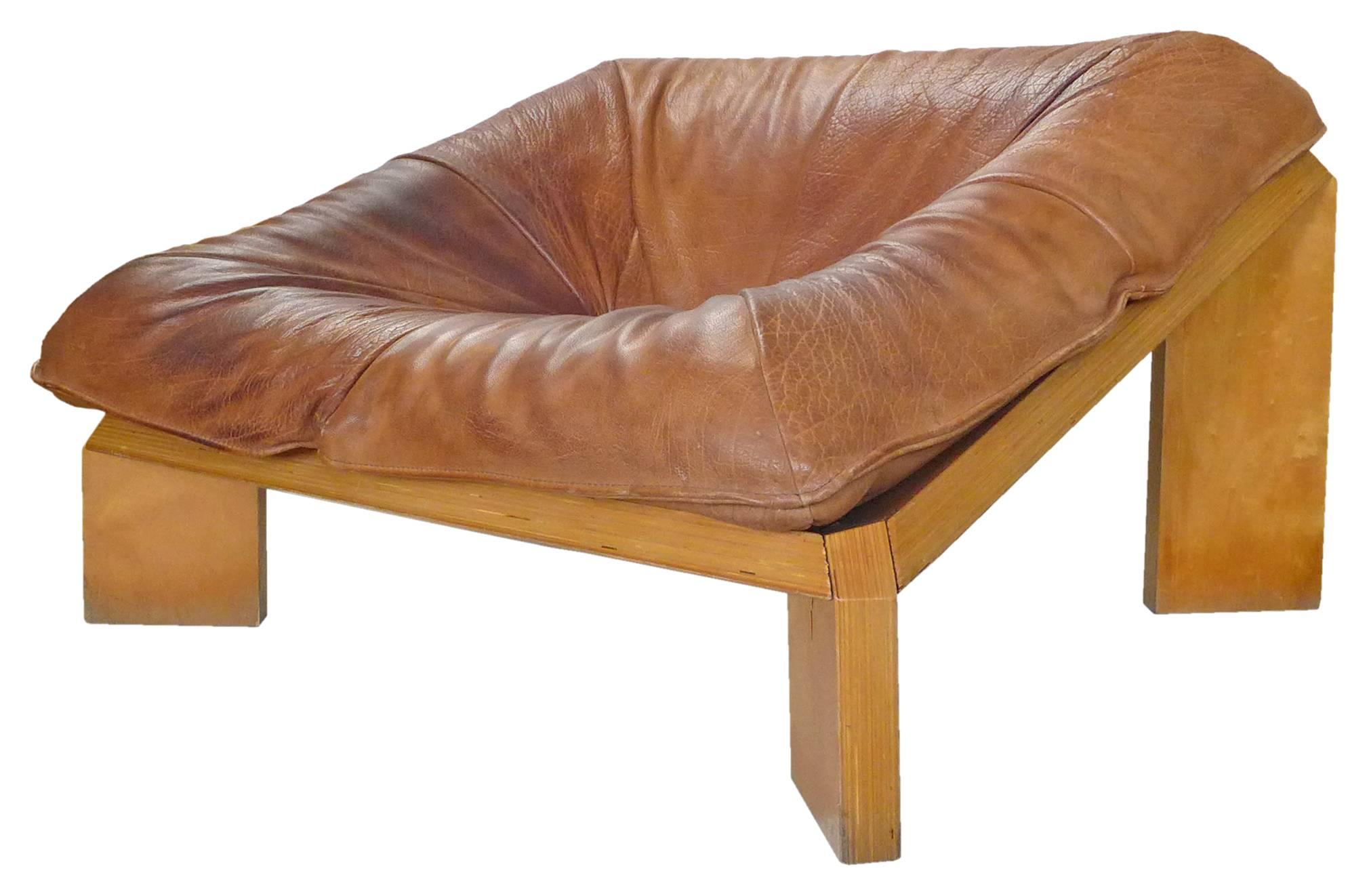 A spectacular and rare "Olso" lounge chair by Gerard Van Den Berg for Montis. An impressive, angular, architectural frame of sturdy, laminated birch cradling a single, overstuffed cushion upholstered in thick, cognac, neck-leather (a