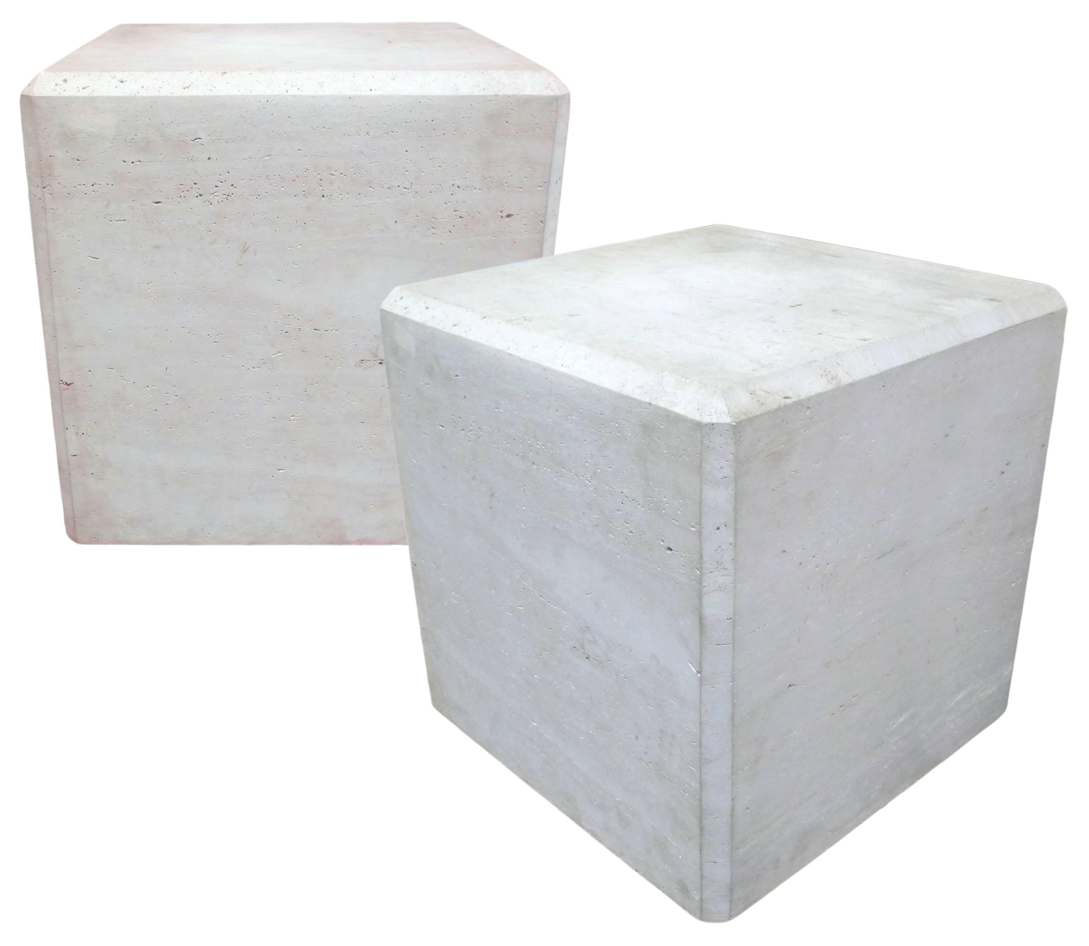 A fantastic pair of large and beautifully Minimalist travertine cubes. Very heavy and well constructed of slab travertine with a wonderful, faceted-edge detail. These forms work well as either pedestals or side tables.
 