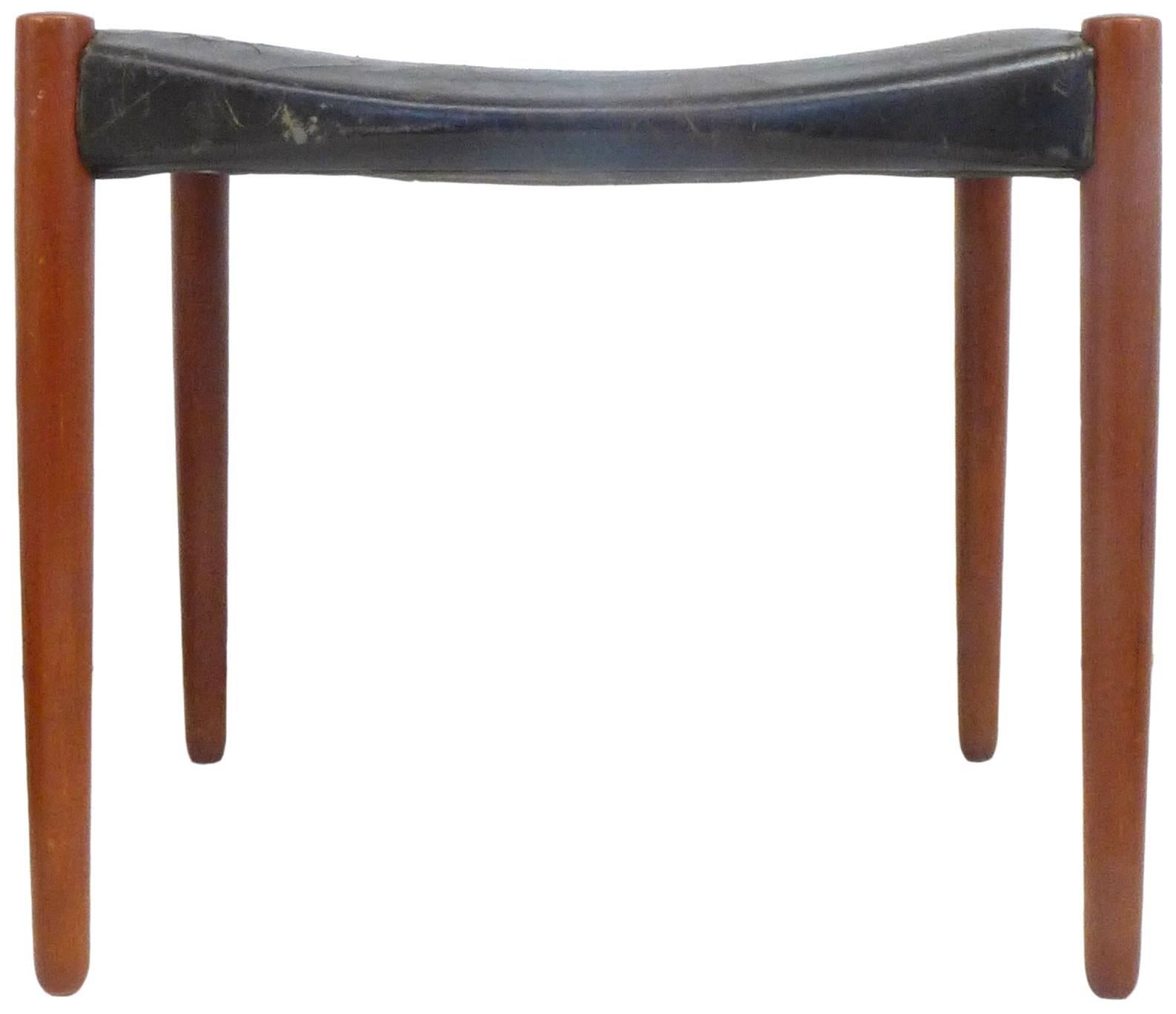 A delightful stool in rosewood and leather designed by Ejner Larsen and A. Bender Madsen for Willy Beck. A subtle and quietly innovative construction: a gently-concave, original-leather seat suspended across four tapered rosewood posts. The
