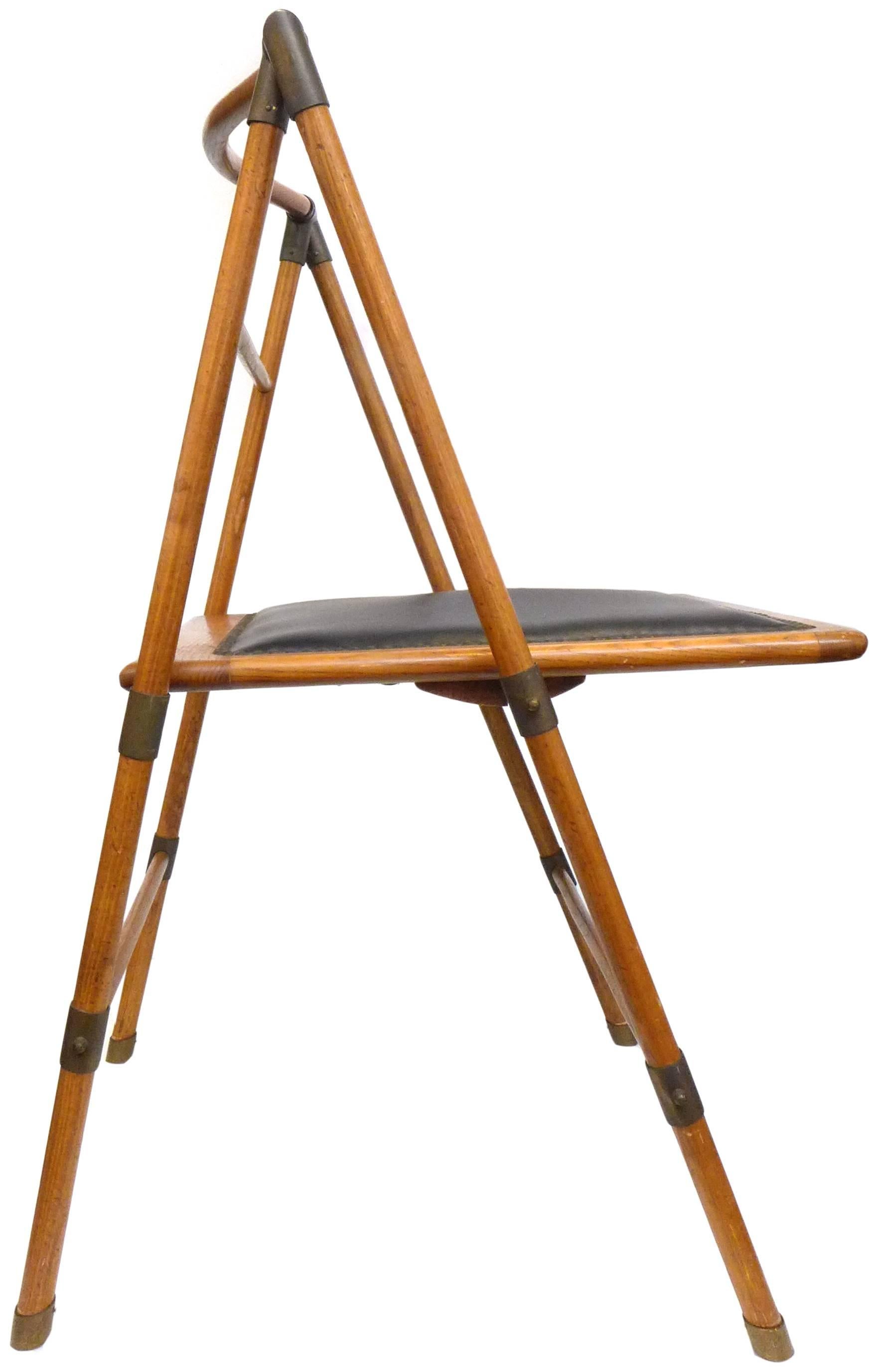 A wonderfully handsome Campaign chair in wood and brass. A beautifully simple and innovative construction: a frame of 1