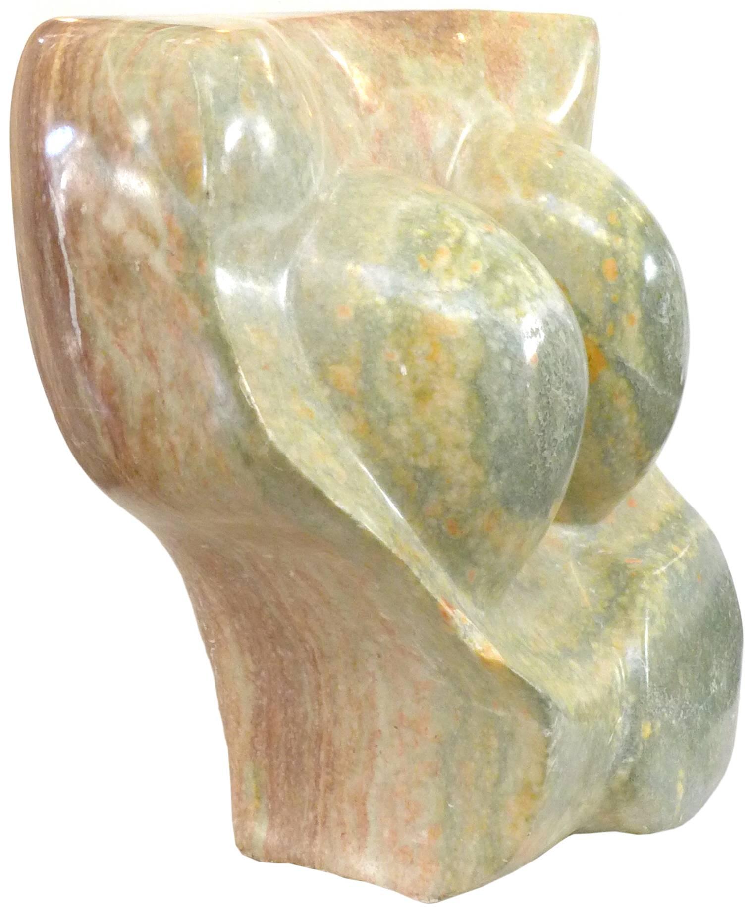 A beautiful and unusual abstract sculpture in carved granite. A stunning piece of polished stone seemingly conveying a female torso. Wonderful, subtle grain and figuring throughout with a color progression of pale jade-green to near brick-red from