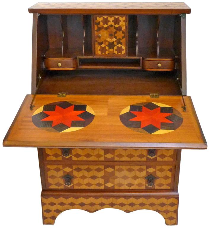 A wonderful and unusual geometric-marquetry secretary. A traditional drop-down secretary taken to another level as an ambitiously artistic woodworking project. The entire facade and top covered in fantastic, geometric, contrasting-woods marquetry